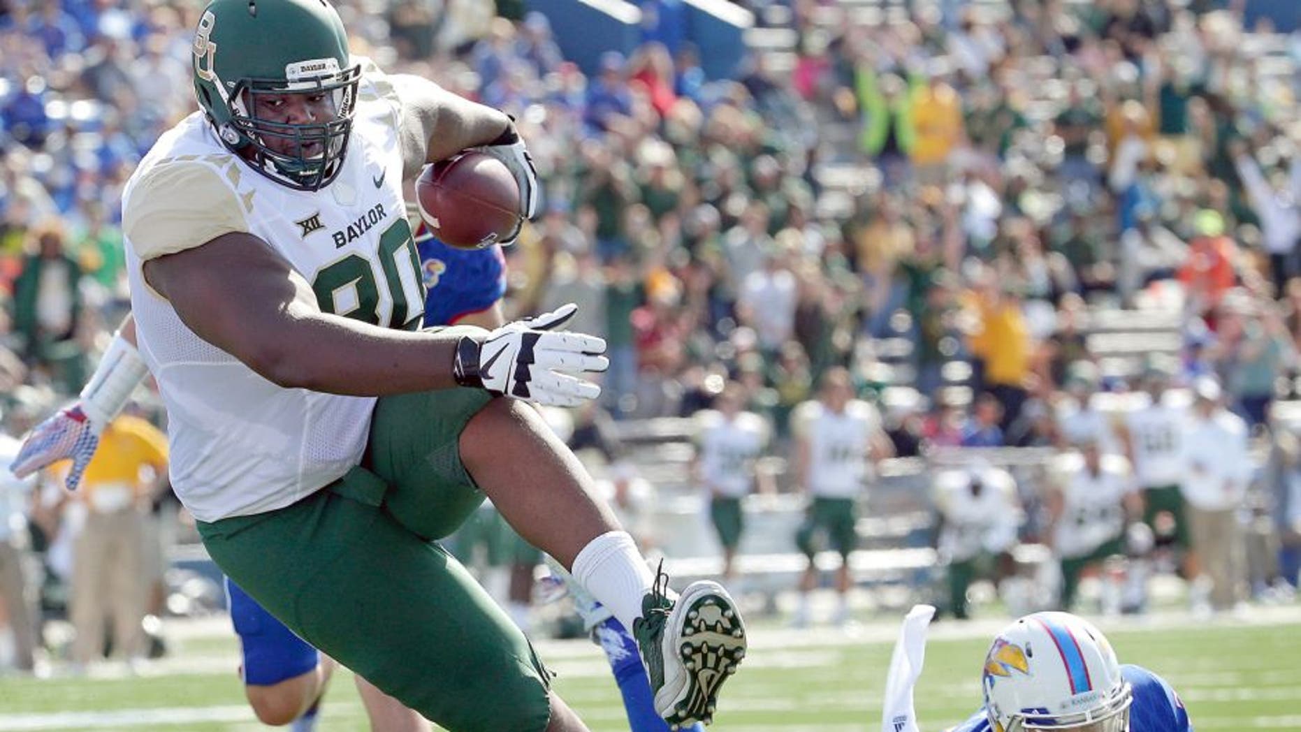 Baylor tight end LaQuan McGowan (80) gets past Kansas safety Michael Glatczak (39) to score a touchdown during the first half of an NCAA college football game, Saturday, Oct. 10, 2015, in Lawrence, Kan. (AP Photo/Charlie Riedel)