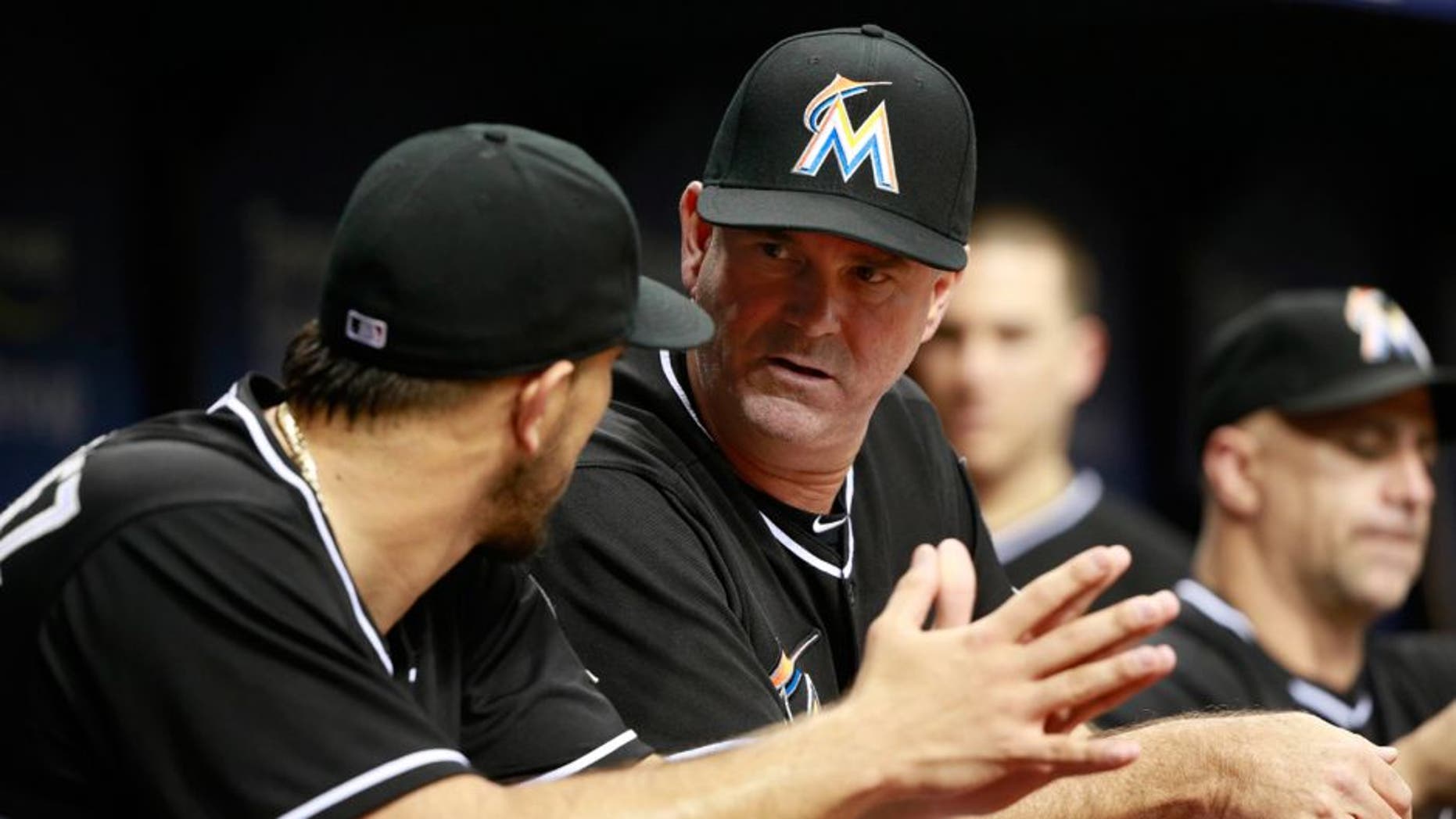 Oct 1, 2015; St. Petersburg, FL, USA; Miami Marlins manager Dan Jennings (26) talks with starting pitcher Jose Fernandez (16) during the fourth inning against the Tampa Bay Rays at Tropicana Field. Mandatory Credit: Kim Klement-USA TODAY Sports