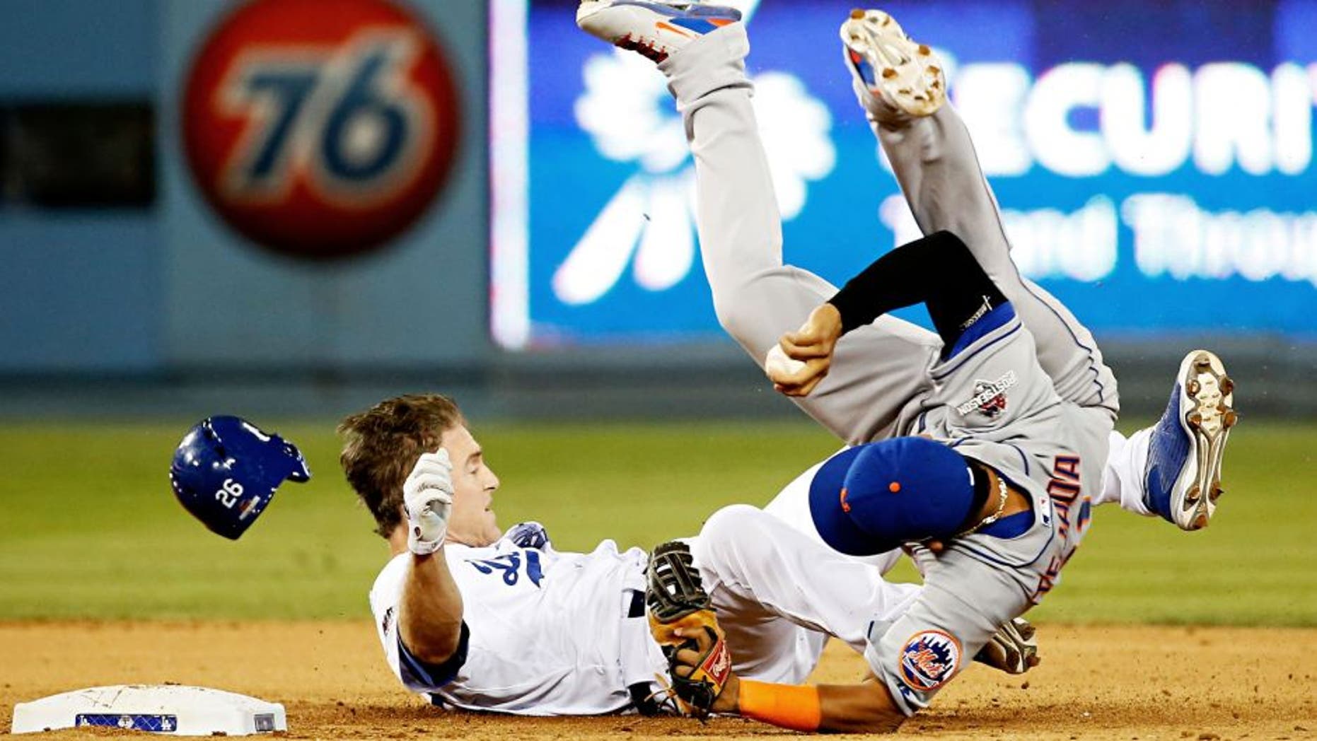 LOS ANGELES, CA - OCTOBER 10: Ruben Tejada #11 of the New York Mets is hit by a slide by Chase Utley #26 of the Los Angeles Dodgers in the seventh inning in an attempt to turn a double play in game two of the National League Division Series at Dodger Stadium on October 10, 2015 in Los Angeles, California. (Photo by Sean M. Haffey/Getty Images)