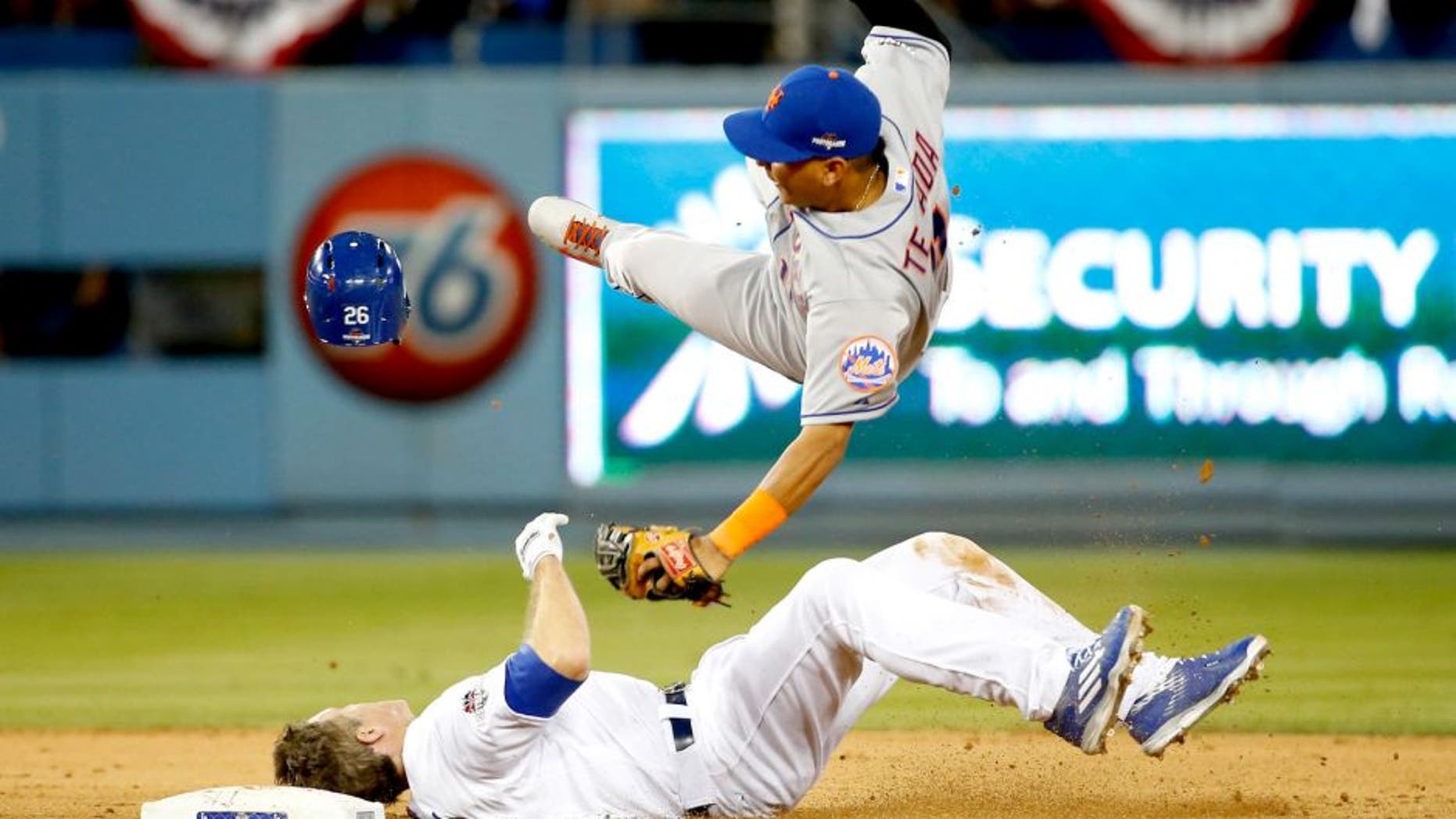 LOS ANGELES, CA - OCTOBER 10: Ruben Tejada #11 of the New York Mets is hit by a slide by Chase Utley #26 of the Los Angeles Dodgers in the seventh inning in an attempt to turn a double play in game two of the National League Division Series at Dodger Stadium on October 10, 2015 in Los Angeles, California. (Photo by Sean M. Haffey/Getty Images)
