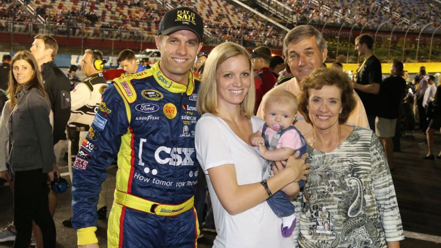 USA -Oct 11: David Ragan, driver of the #34 CSX - Play It Safe Ford Fusion, poses for a photo with his wife Jacquelyn and family prior to the start of the NASCAR Sprint Cup Series Bank of America 500 at the Charlotte Motor Speedway in Concord, NC. Picture taken on Oct 11, 2014 in the United States. (Photo by Jim Fluharty/NASCAR Illustrated/Sporting News via Getty Images)