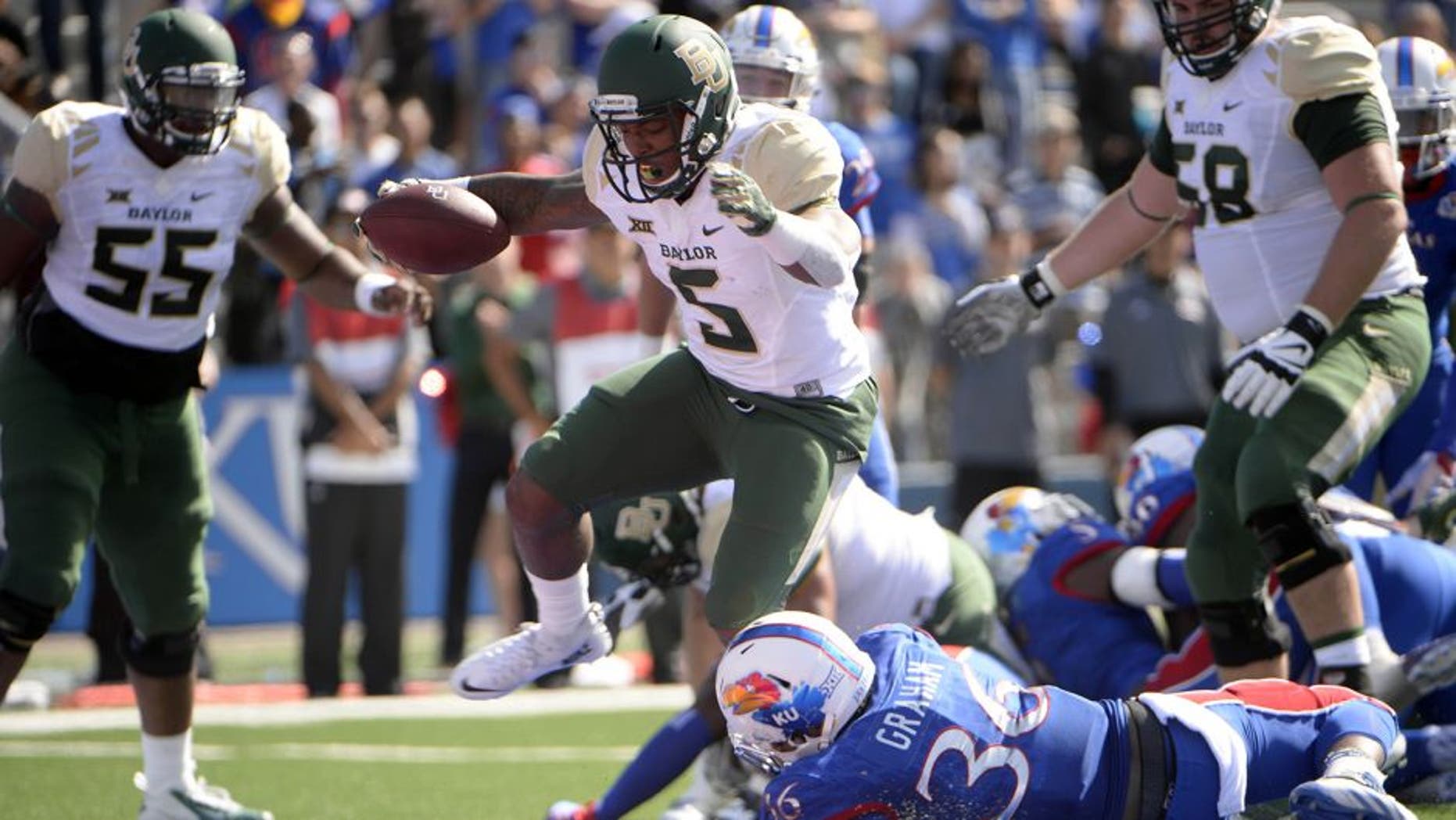 Oct 10, 2015; Lawrence, KS, USA; Baylor Bears running back Johnny Jefferson (5) rushes for a touchdown against Kansas Jayhawks cornerback Chevy Graham (36) in the first half at Memorial Stadium. Mandatory Credit: John Rieger-USA TODAY Sports