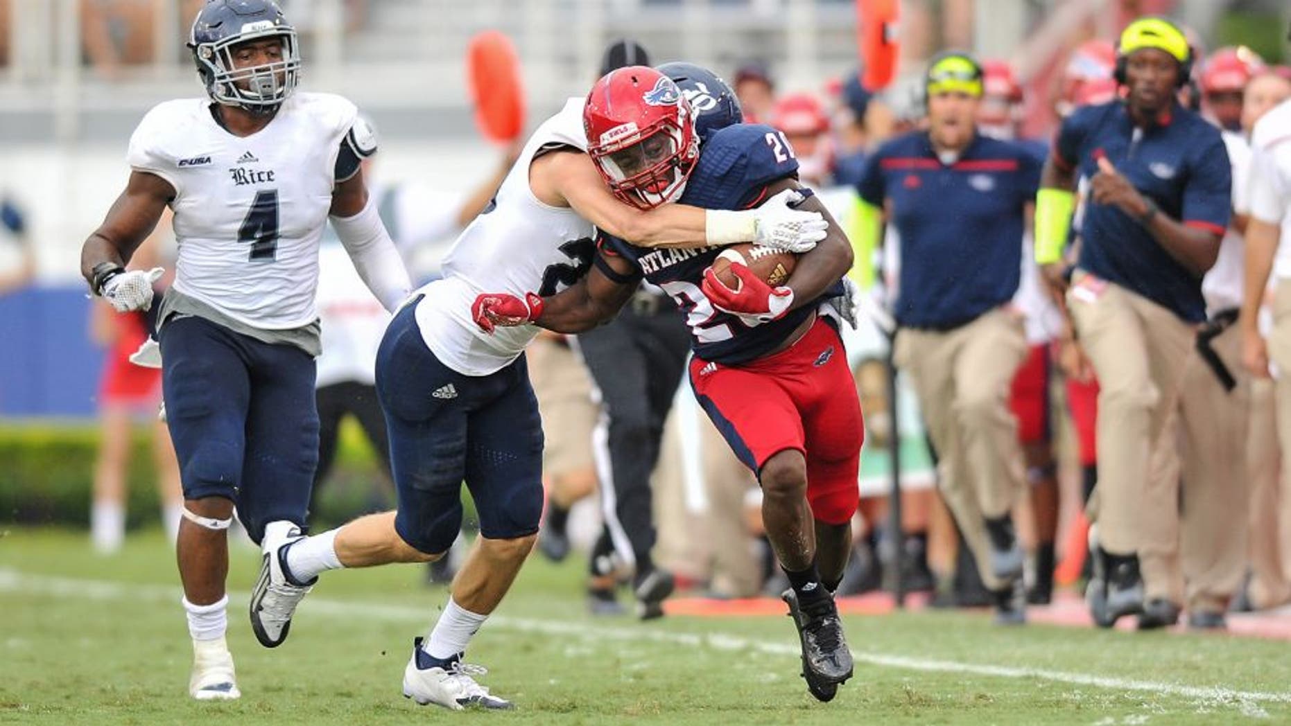 Oct 10, 2015; Boca Raton, FL, USA; Florida Atlantic Owls running back Marcus Clark (20) runs is tackled by Rice Owls cornerback Jorian Clark (20) during the second half at FAU Football Stadium. Mandatory Credit: Steve Mitchell-USA TODAY Sports