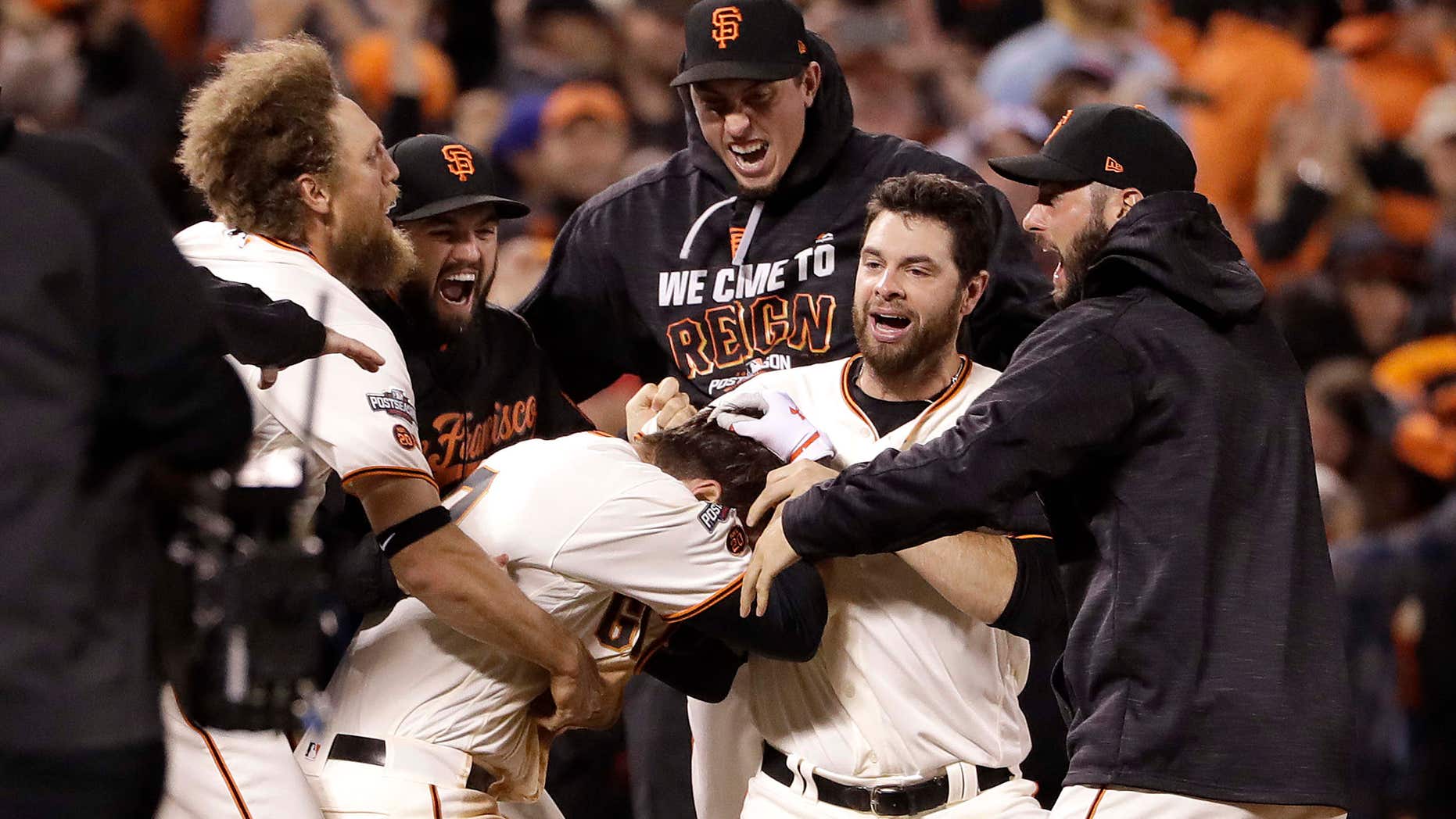 Oct. 10, 2016: San Francisco Giants' Joe Panik, center bottom, is congratulated by teammates after hitting a double to score Brandon Crawford during the thirteenth inning of Game 3 of baseball's National League Division Series against the Chicago Cubs in San Francisco.
