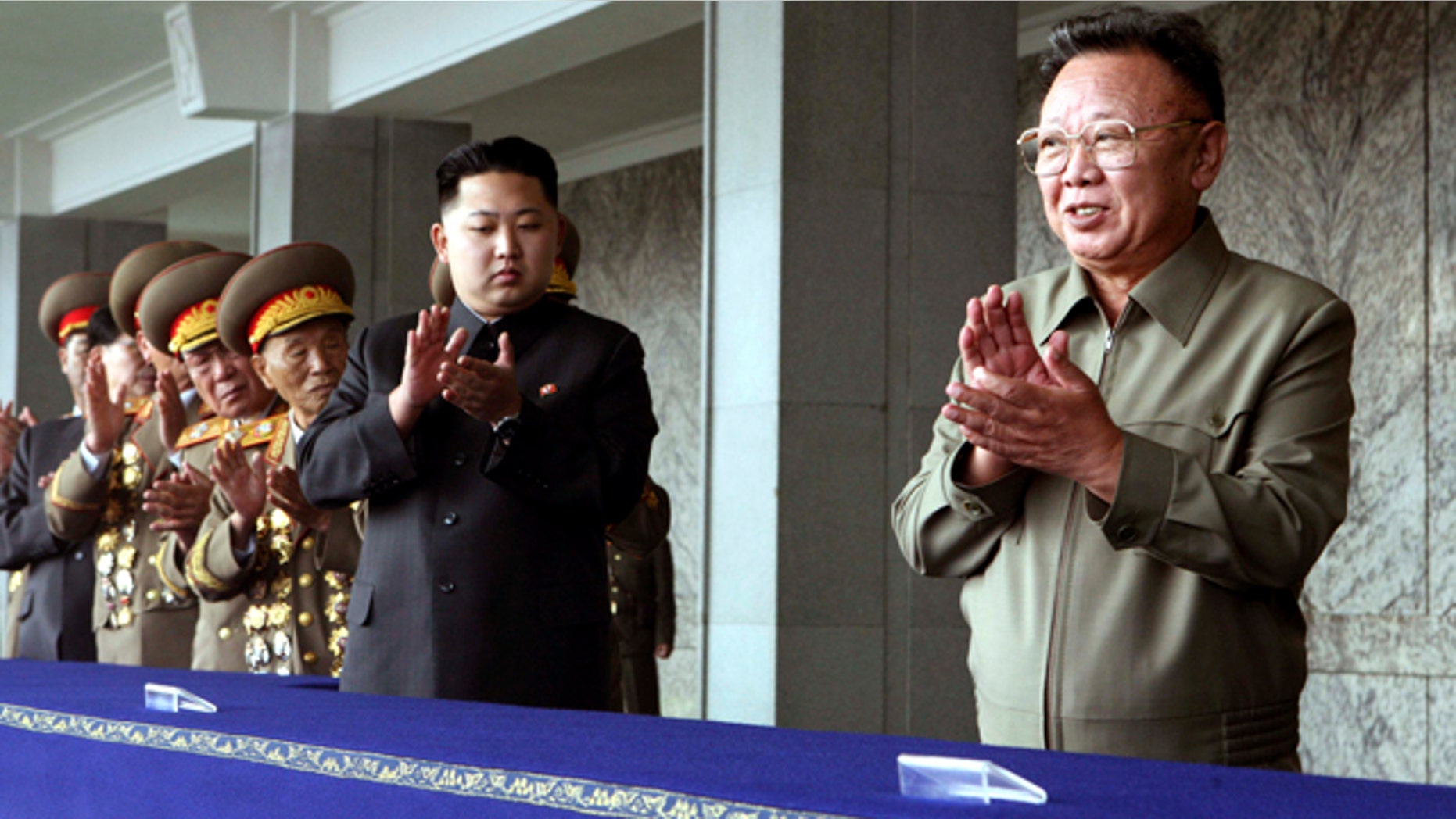Oct. 11: In this photo released by China's Xinhua News Agency, North Korean leader Kim Jong Il, right, and his third son Kim Jong Un, center, applaud before a massive military parade celebrating the 65th anniversary of the communist nation's Workers' Party, in Pyongyang, North Korea.