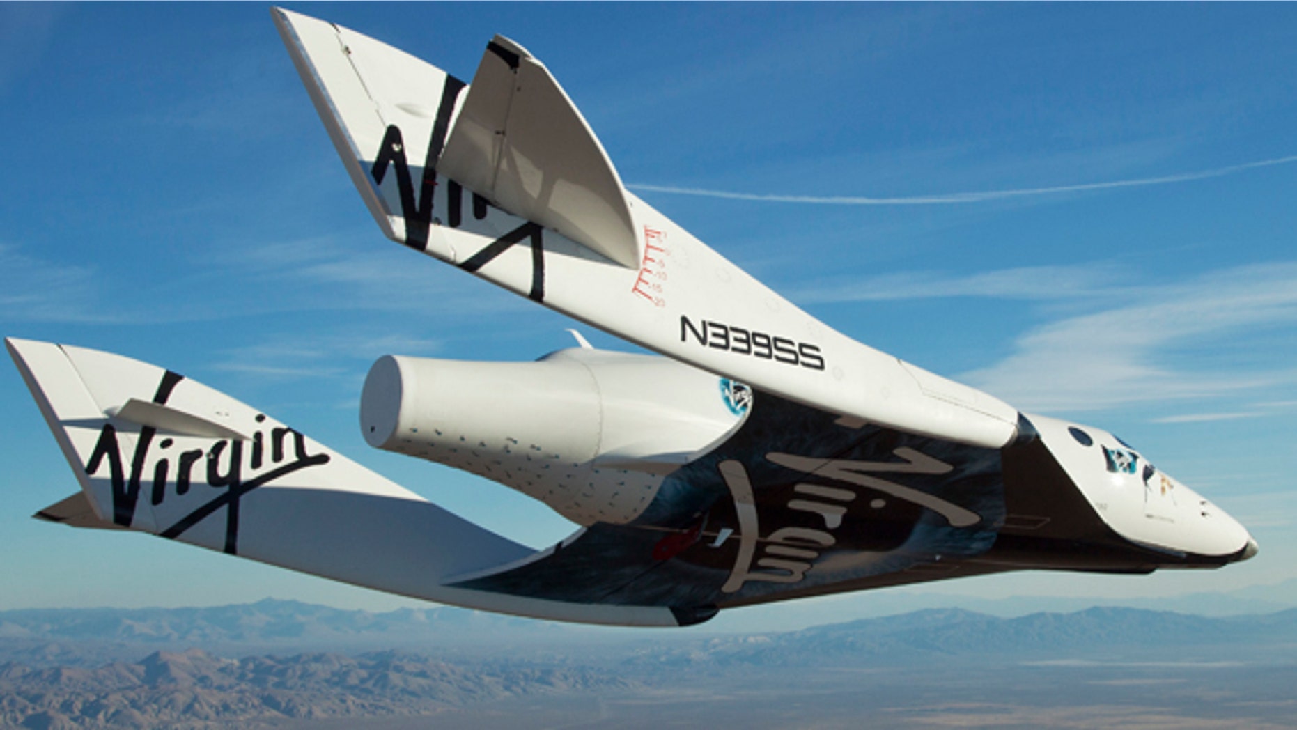 Oct. 10: In this photo released by Virgin Galactic, the Virgin Galactic SpaceShipTwo, or VSS Enterprise, glides toward the earth on its first test flight after release from the mothership, WhiteKnight2, also known as VMS Eve, over the Mojave, Calif., area.