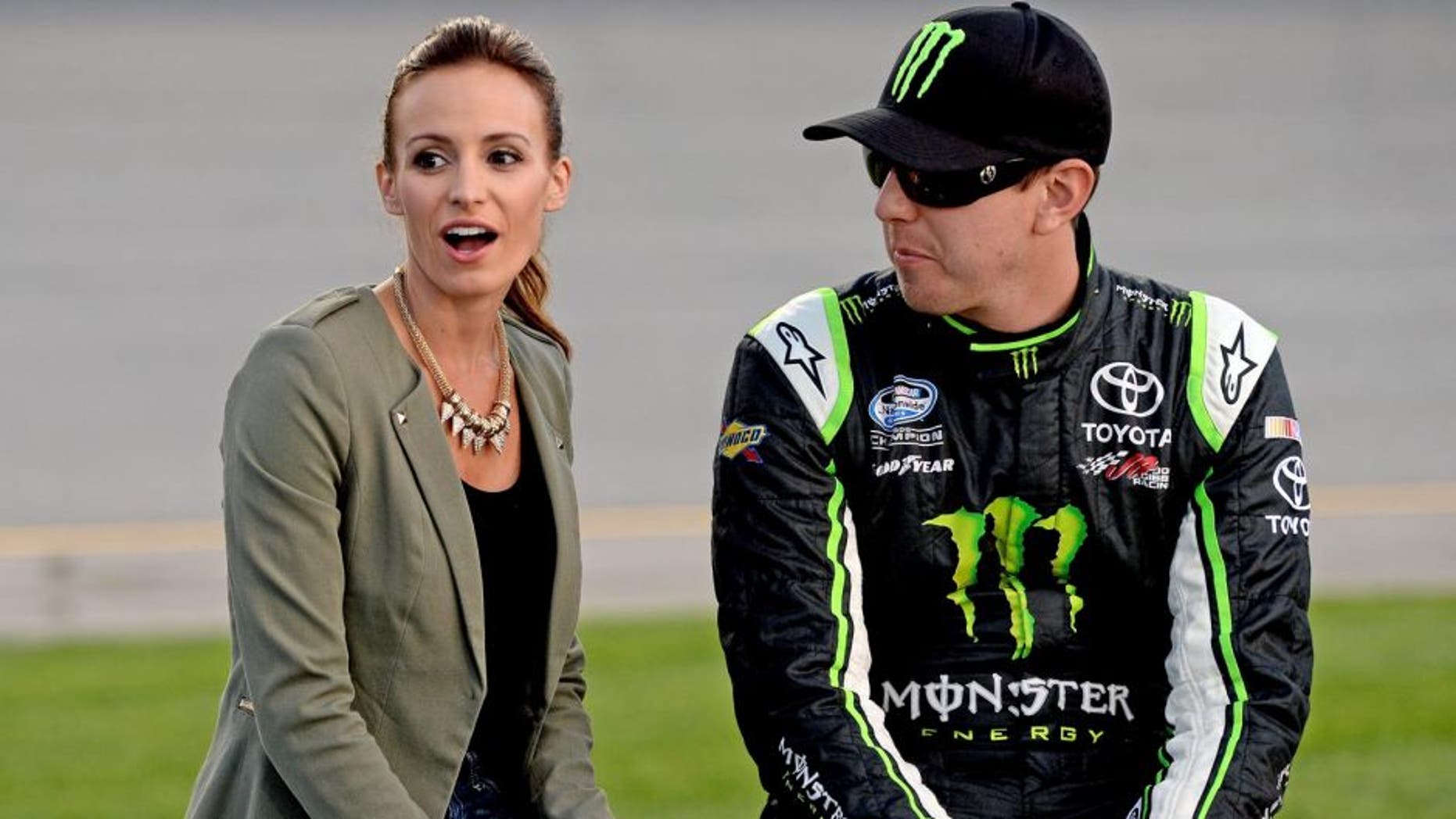 RICHMOND, VA - SEPTEMBER 06: (R-L) Kyle Busch, driver of the #54 Monster Energy Toyota, and wife Samantha Busch take part in pre-race ceremonies for the NASCAR Nationwide Series Virginia 529 College Savings 250 at Richmond International Raceway on September 6, 2013 in Richmond, Virginia. (Photo by Patrick Smith/Getty Images)