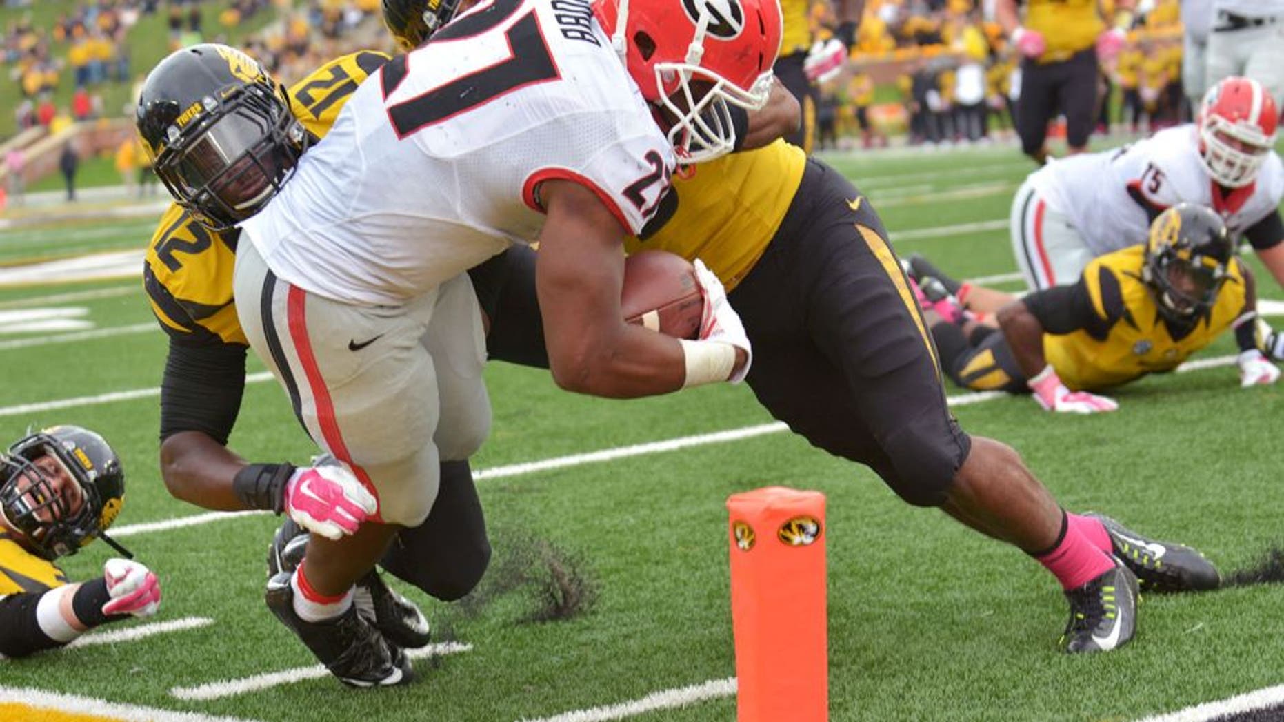 Oct 11, 2014; Columbia, MO, USA; Georgia Bulldogs running back Nick Chubb (27) scores a touchdown as Missouri Tigers linebacker Darvin Ruise (12) and safety Braylon Webb (9) make the tackle during the second half at Faurot Field. Georgia won 34-0. Mandatory Credit: Denny Medley-USA TODAY Sports