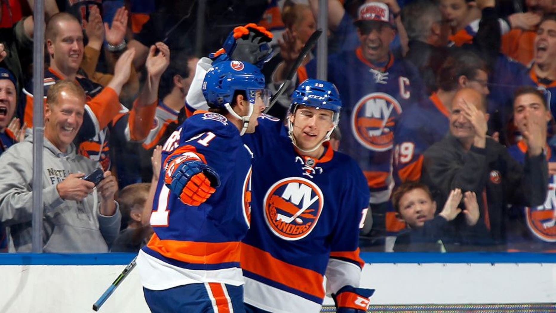 UNIONDALE, NY - OCTOBER 11: John Tavares #91 (L) and Ryan Strome #18 of the New York Islanders celebrate Tavares' first period goal against the Carolina Hurricanes at the Nassau Veterans Memorial Coliseum on October 11, 2014 in Uniondale, New York. (Photo by Bruce Bennett/Getty Images)