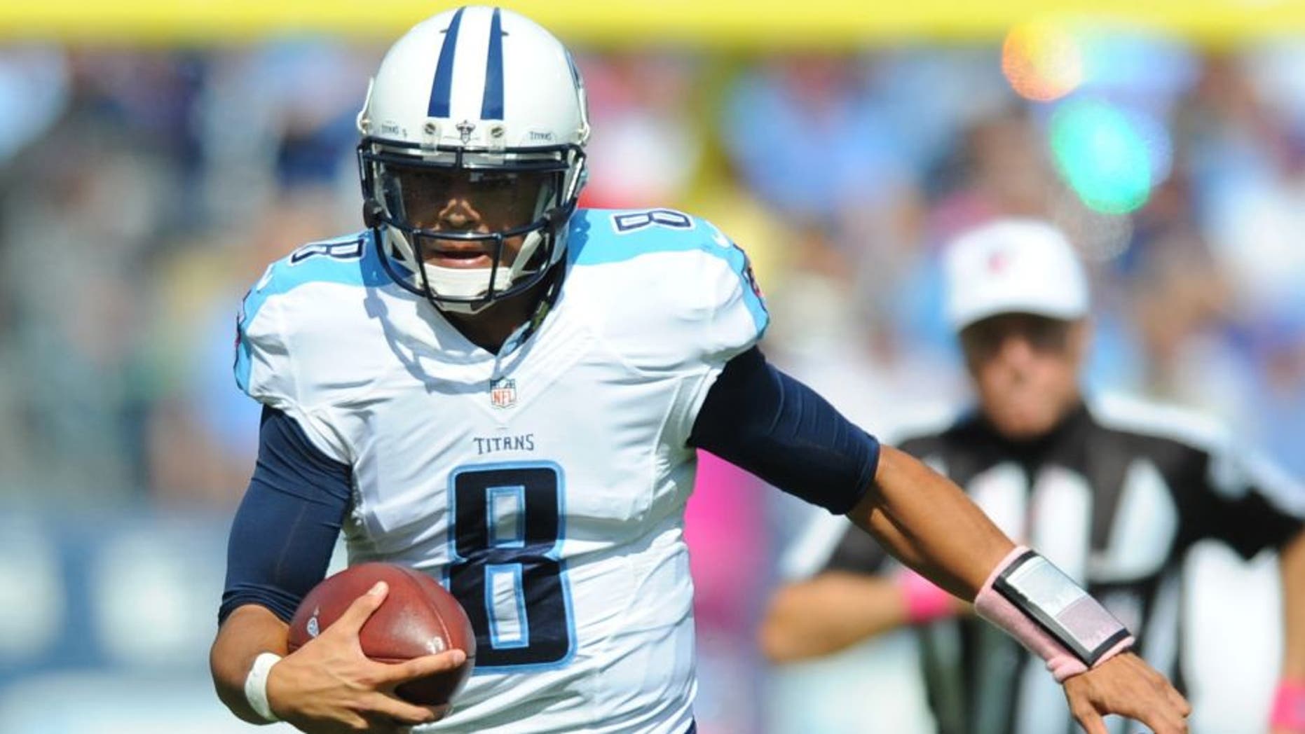 Oct 11, 2015; Nashville, TN, USA; Tennessee Titans quarterback Marcus Mariota (8) runs for a short gain during the first half against the Buffalo Bills at Nissan Stadium. Mandatory Credit: Christopher Hanewinckel-USA TODAY Sports