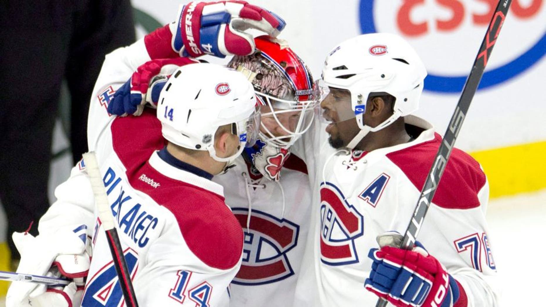 Montreal Canadiens defenseman P.K. Subban, right, and center Tomas Plekanec congratulate goalie Mike Condon as the Canadiens defeat the Ottawa Senators in an NHL hockey game, Sunday, Oct. 11, 2015 in Ottawa, Ontario. (Adrian Wyld/The Canadian Press via AP) MANDATORY CREDIT
