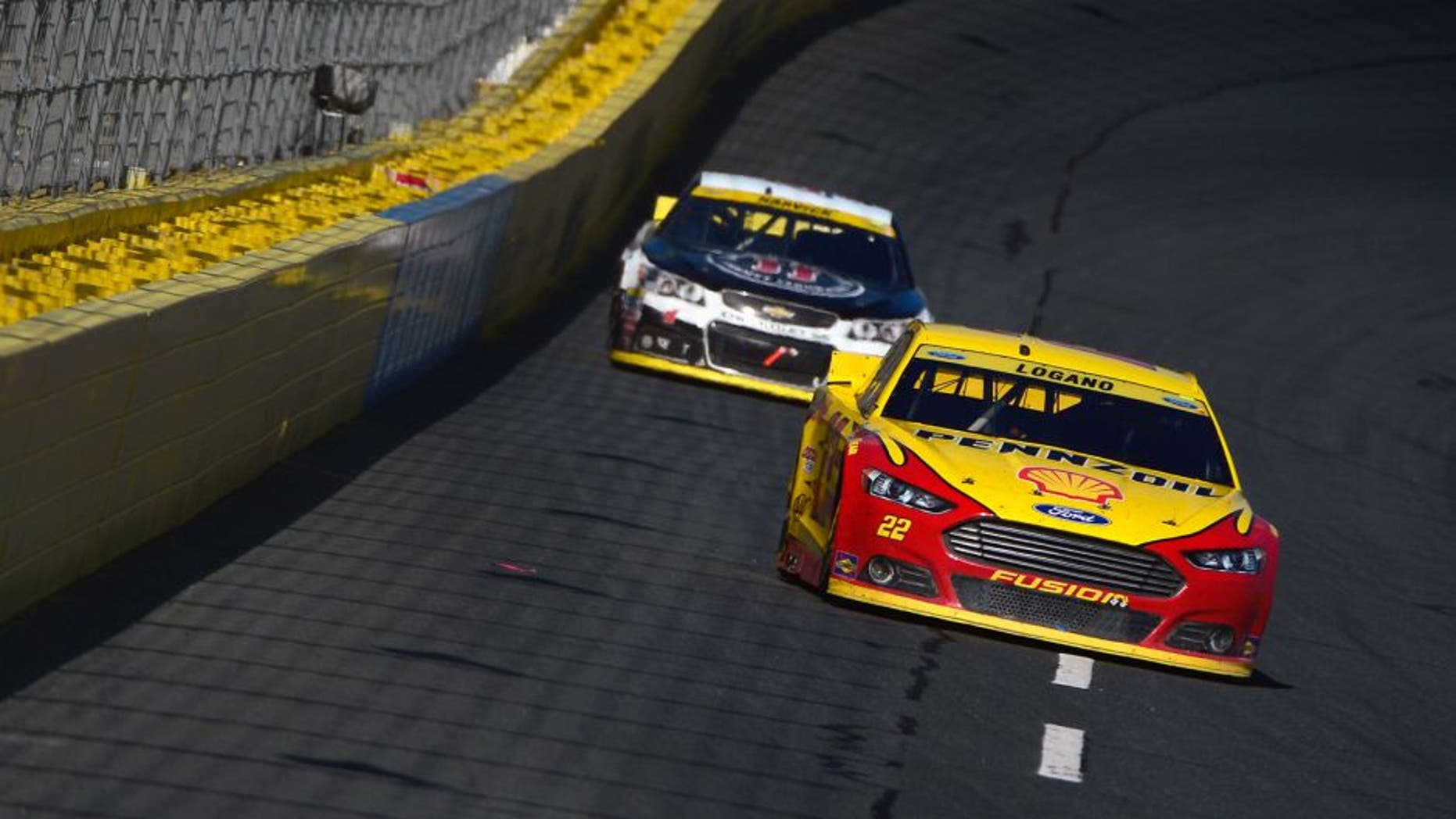 CHARLOTTE, NC - OCTOBER 11: Joey Logano, driver of the #22 Shell Pennzoil Ford, leads Kevin Harvick, driver of the #4 Jimmy John's/Budweiser Chevrolet, during the NASCAR Sprint Cup Series Bank of America 500 at Charlotte Motor Speedway on October 11, 2015 in Charlotte, North Carolina. (Photo by Robert Laberge/NASCAR via Getty Images)