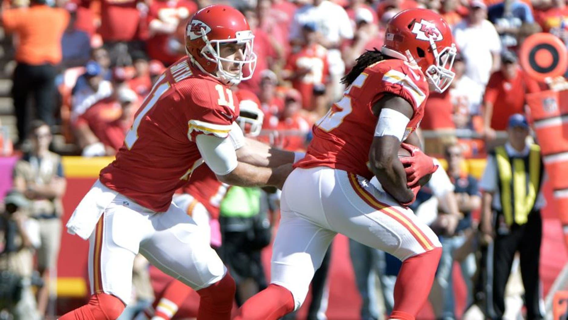 Oct 11, 2015; Kansas City, MO, USA; Kansas City Chiefs quarterback Alex Smith (11) hands off to running back Jamaal Charles (25) during the first half against the Chicago Bears at Arrowhead Stadium. Mandatory Credit: Denny Medley-USA TODAY Sports