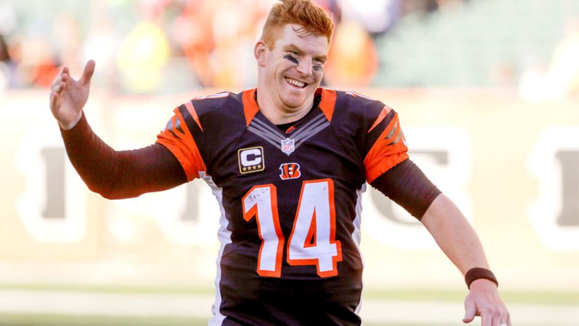 Oct 11, 2015; Cincinnati, OH, USA; Cincinnati Bengals quarterback Andy Dalton (14) celebrates after his team defeated the Seattle Seahawks at Paul Brown Stadium. Cincinnati defeated Seattle 27-24. Mandatory Credit: Mark Zerof-USA TODAY Sports
