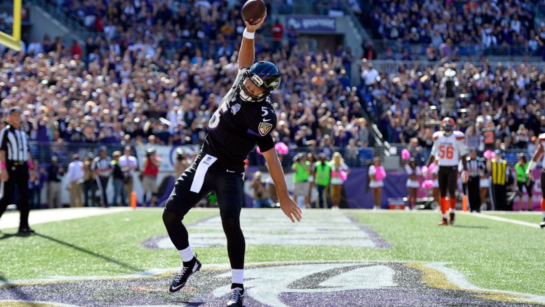 Oct 11, 2015; Baltimore, MD, USA; Baltimore Ravens quarterback Joe Flacco (5) celebrates after scoring a running touchdown during the first quarter against the Cleveland Browns at M&T Bank Stadium. Mandatory Credit: Tommy Gilligan-USA TODAY Sports