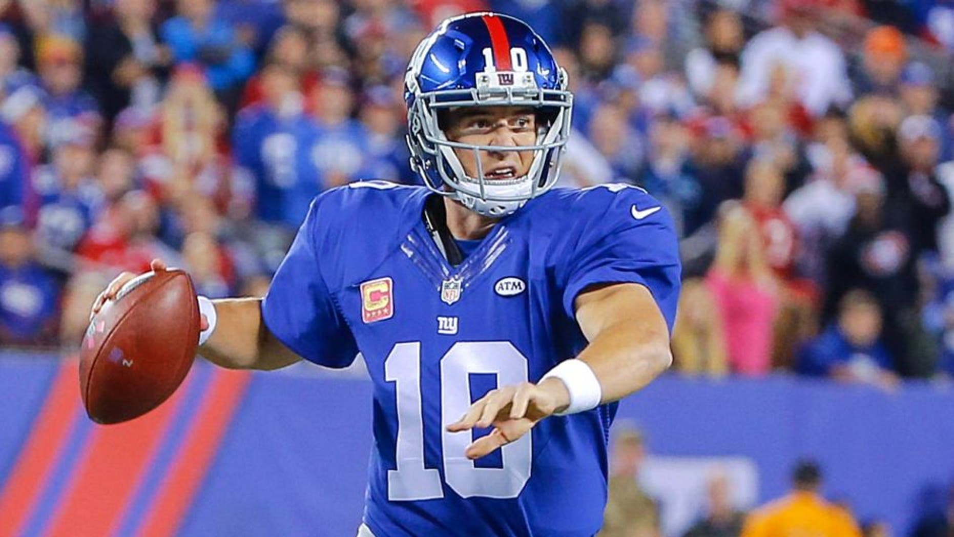 Oct 11, 2015; East Rutherford, NJ, USA; New York Giants quarterback Eli Manning (10) prepares to throw the ball during the first quarter against the San Francisco 49ers at MetLife Stadium. Mandatory Credit: Jim O'Connor-USA TODAY Sports