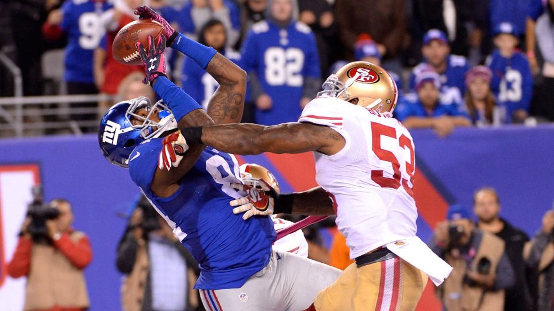 Oct 11, 2015; East Rutherford, NJ, USA; New York Giants tight end Larry Donnell (84) catches the game winning touchdown in front of San Francisco 49ers inside linebacker NaVorro Bowman (53) during the fourth quarter at MetLife Stadium. Mandatory Credit: Robert Deutsch-USA TODAY Sports