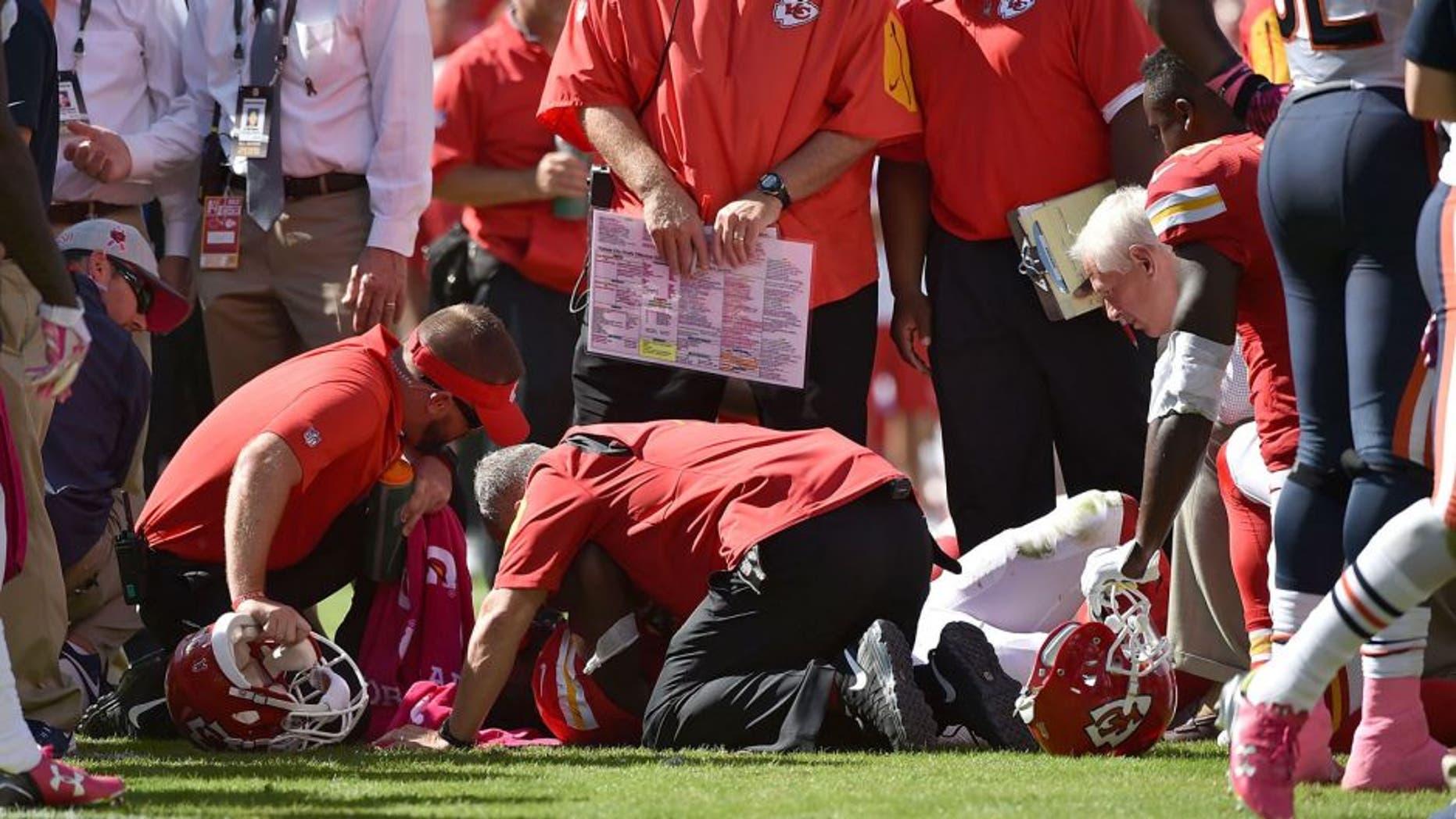 KANSAS CITY, MO - OCTOBER 11: Kansas City Chiefs training staff attends to an injury for Jamaal Charles #25 of the Kansas City Chiefs after a run with head coach Andy Reid of the Kansas City Chiefs overlooking at Arrowhead Stadium during the game against the Chicago Bears on October 11, 2015 in Kansas City, Missouri. (Photo by Peter Aiken/Getty Images)