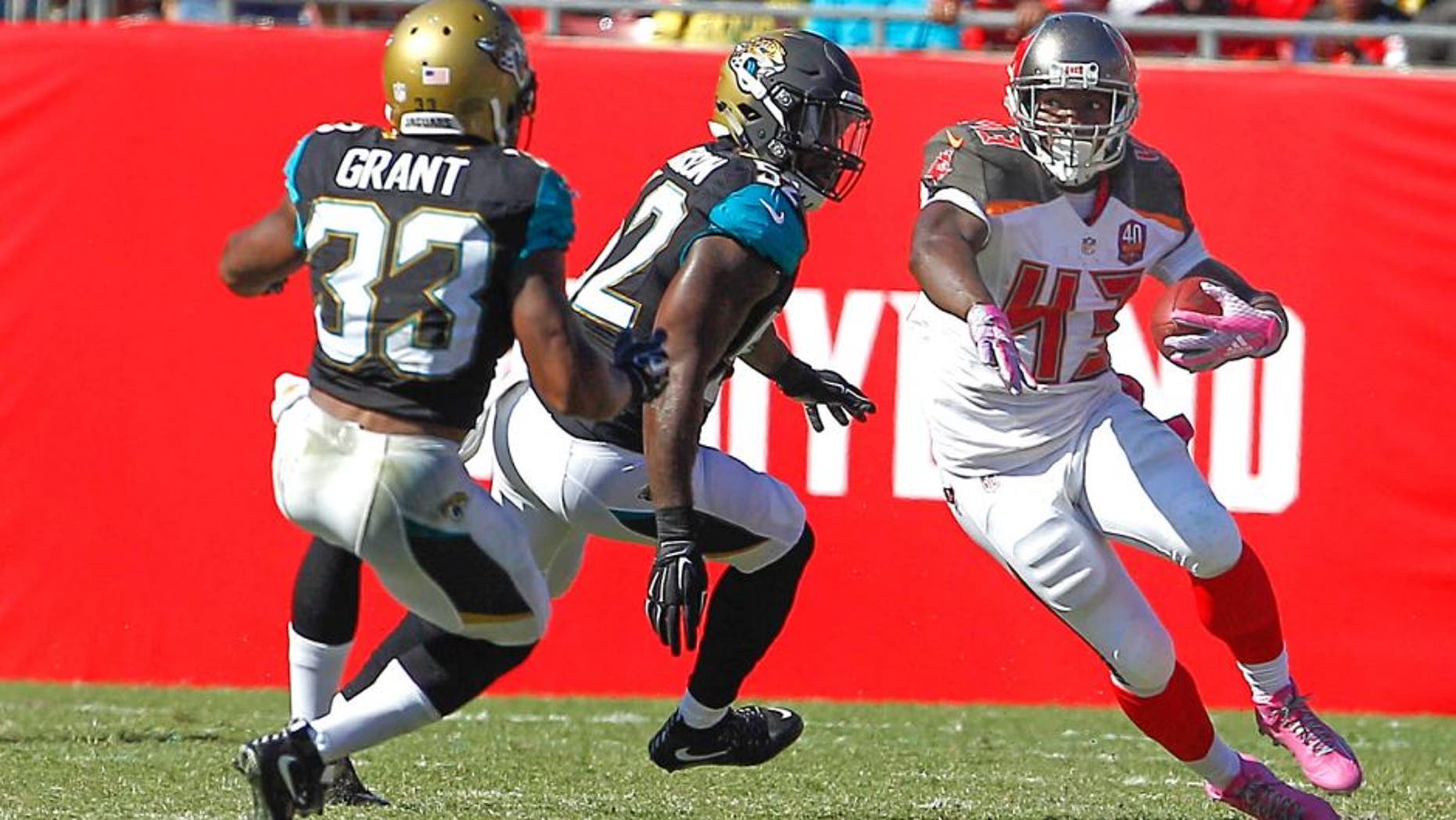 Oct 11, 2015; Tampa, FL, USA;Jacksonville Jaguars running back Corey Grant (33) and James Michael-Johnson (52) chase Tampa Bay Buccaneers running back Bobby Rainey (43) during the second half of an NFL football game at Raymond James Stadium. Tampa won 38-31. Mandatory Credit: Reinhold Matay-USA TODAY Sports