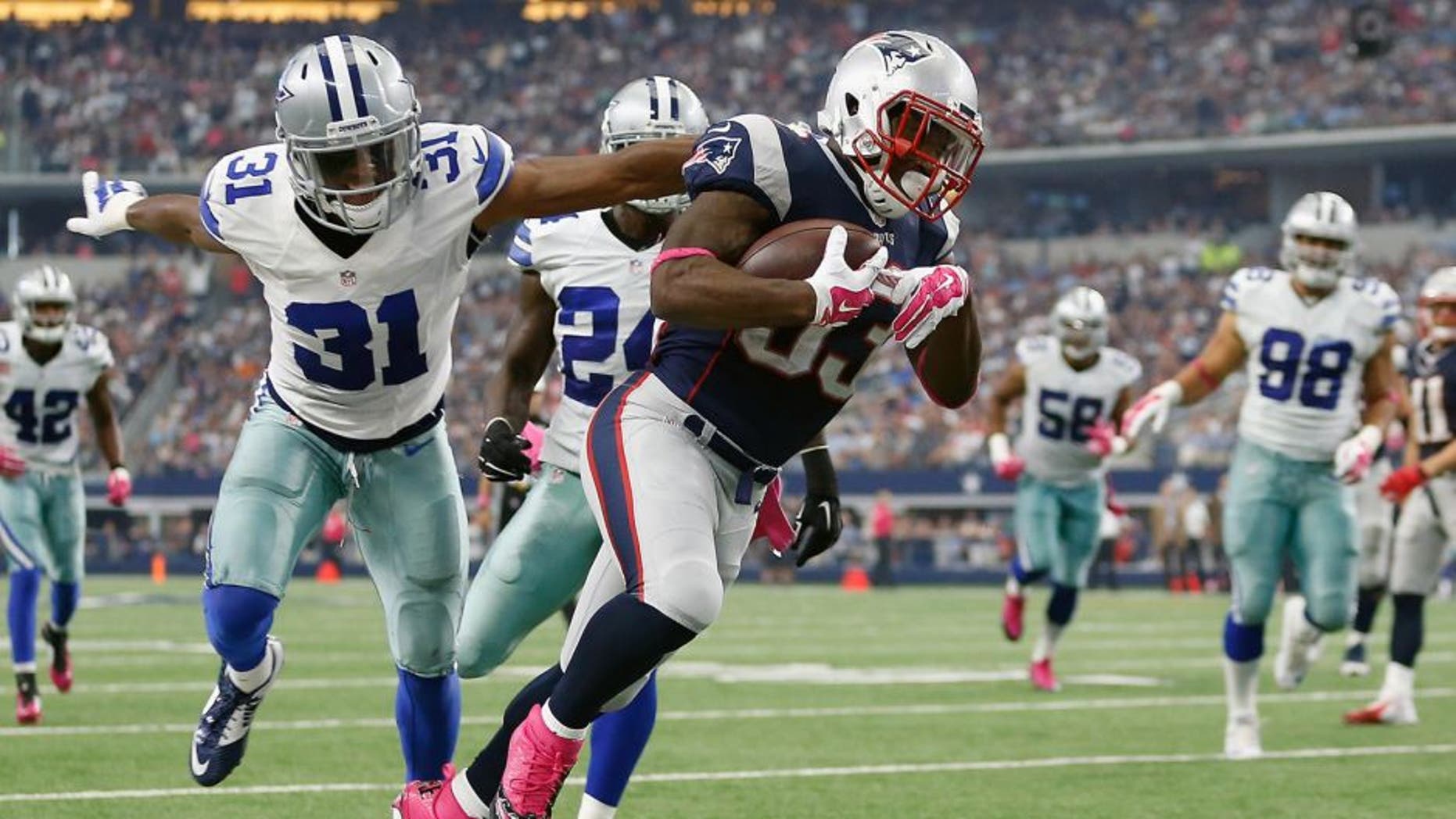 ARLINGTON, TX - OCTOBER 11: Running back Dion Lewis #33 of the New England Patriots carries the ball as cornerback Byron Jones #31 of the Dallas Cowboys tries to make the tackle during the first half of the NFL game at AT&T Stadium on October 11, 2015 in Arlington, Texas. (Photo by Christian Petersen/Getty Images)