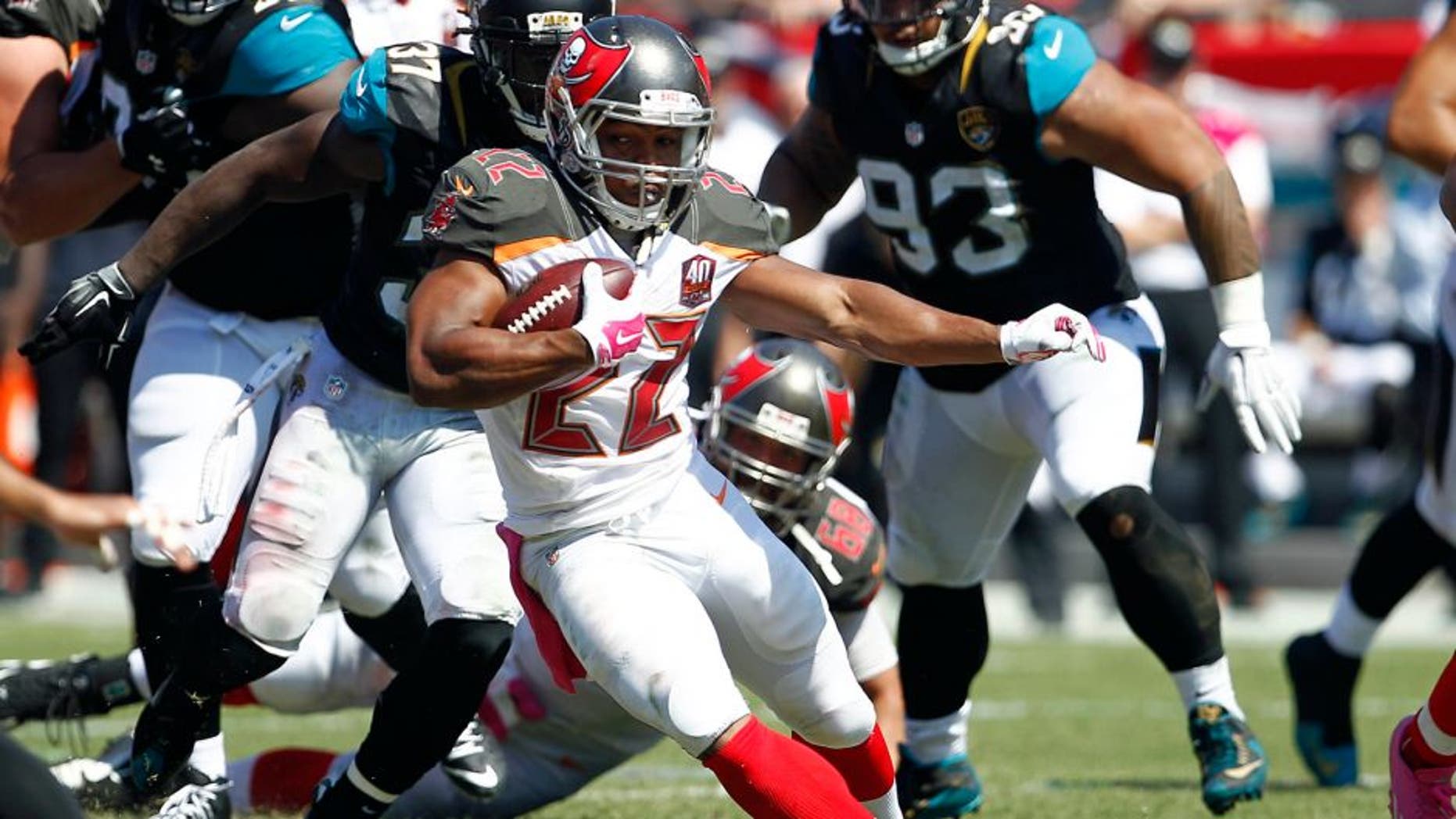 Oct 11, 2015; Tampa, FL, USA; Tampa Bay Buccaneers running back Doug Martin (22) runs for a first down during past Jacksonville Jaguars strong safety Johnathan Cyprien (37) the second quarter of an NFL football game at Raymond James Stadium. Mandatory Credit: Reinhold Matay-USA TODAY Sports