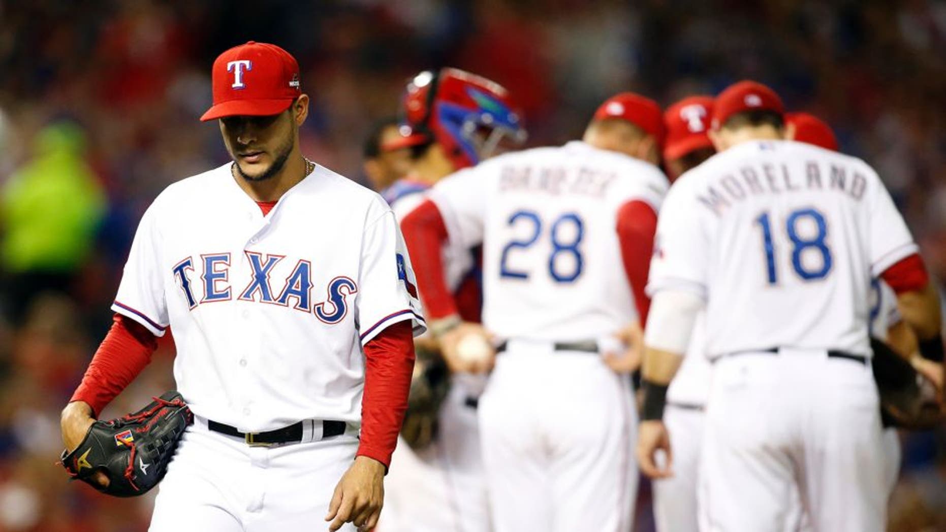 Oct 11, 2015; Arlington, TX, USA; Texas Rangers starting pitcher Martin Perez (left) walks to the dugout after being relieved against the Toronto Blue Jays in the 6th inning in game three of the ALDS at Globe Life Park in Arlington. Mandatory Credit: Tim Heitman-USA TODAY Sports