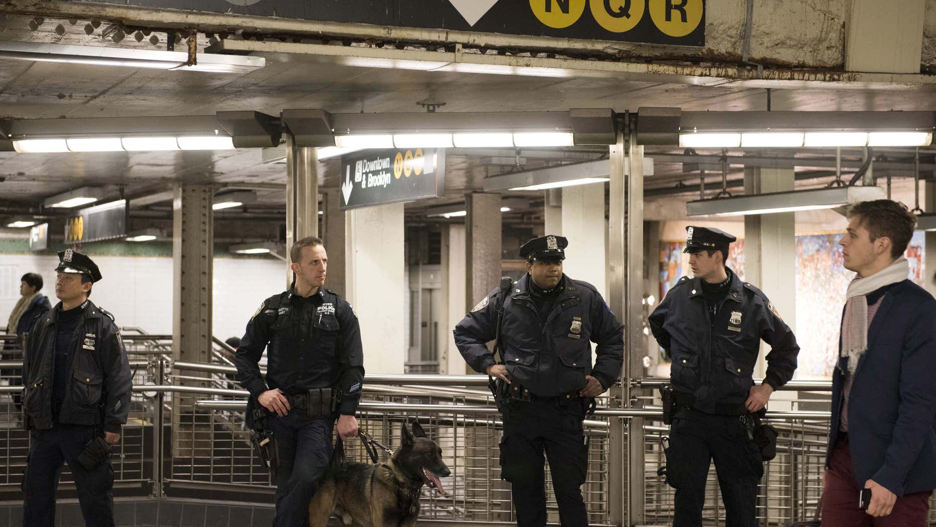 Dec. 31, 2015: New York Police Department officers stand guard inside the Times Square subway station ahead of New Year's Eve celebrations in New York.