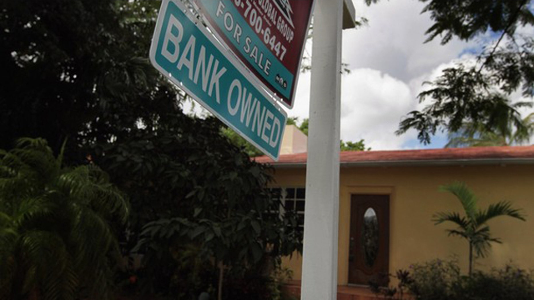 Sept. 16: A bank owned sign is seen in front of a foreclosed home in Miami.