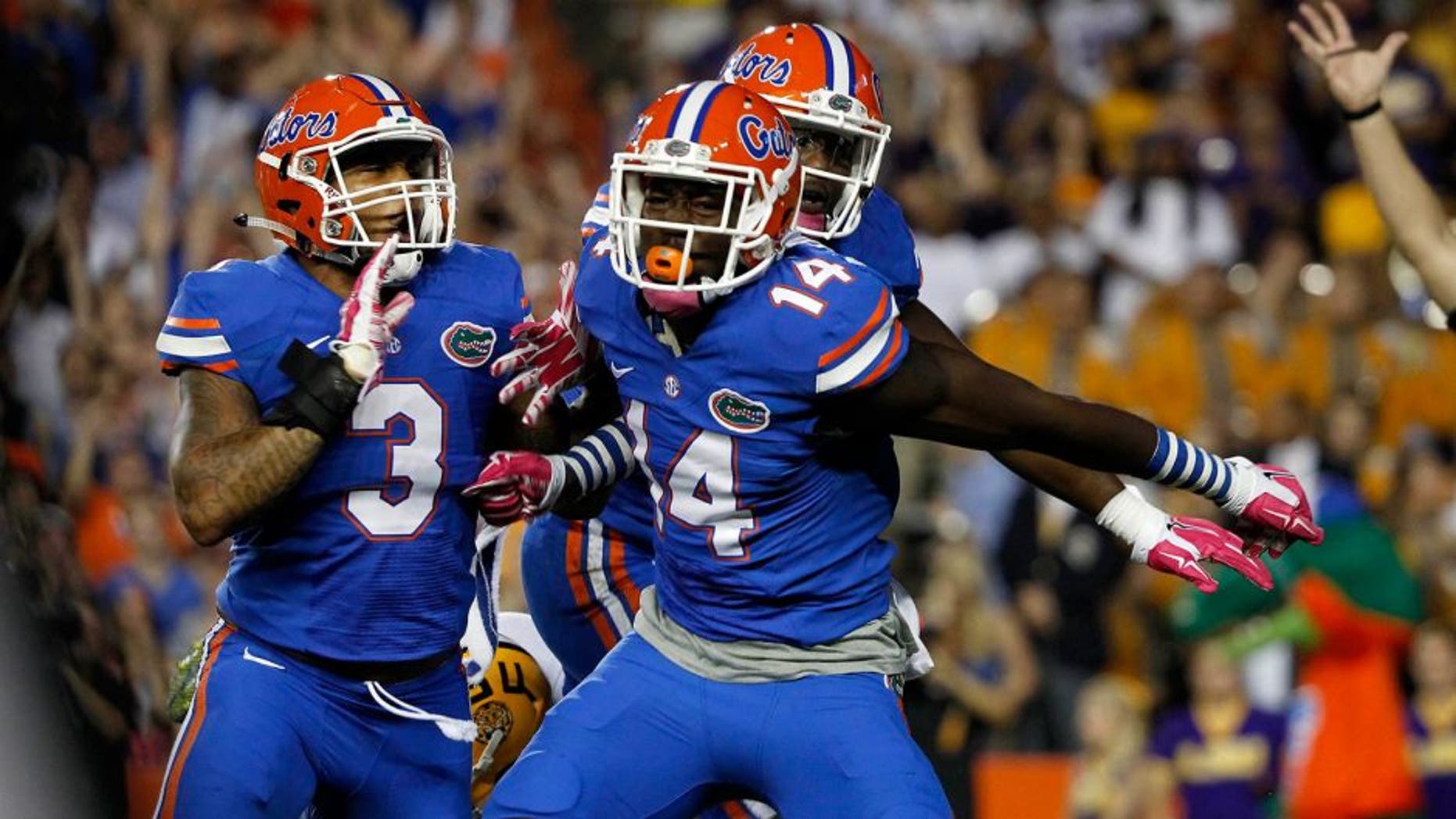 Oct 11, 2014; Gainesville, FL, USA; Florida Gators defensive lineman Alex McCalister (14) reacts after he sacks LSU Tigers quarterback Anthony Jennings (10) during the first quarter at Ben Hill Griffin Stadium. Mandatory Credit: Kim Klement-USA TODAY Sports