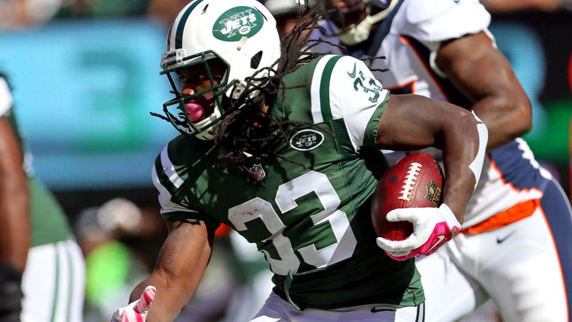 Oct 12, 2014; East Rutherford, NJ, USA; New York Jets running back Chris Ivory (33) rushes against the Denver Broncos during the first quarter of their NFL football game at MetLife Stadium. Mandatory Credit: Adam Hunger-USA TODAY Sports