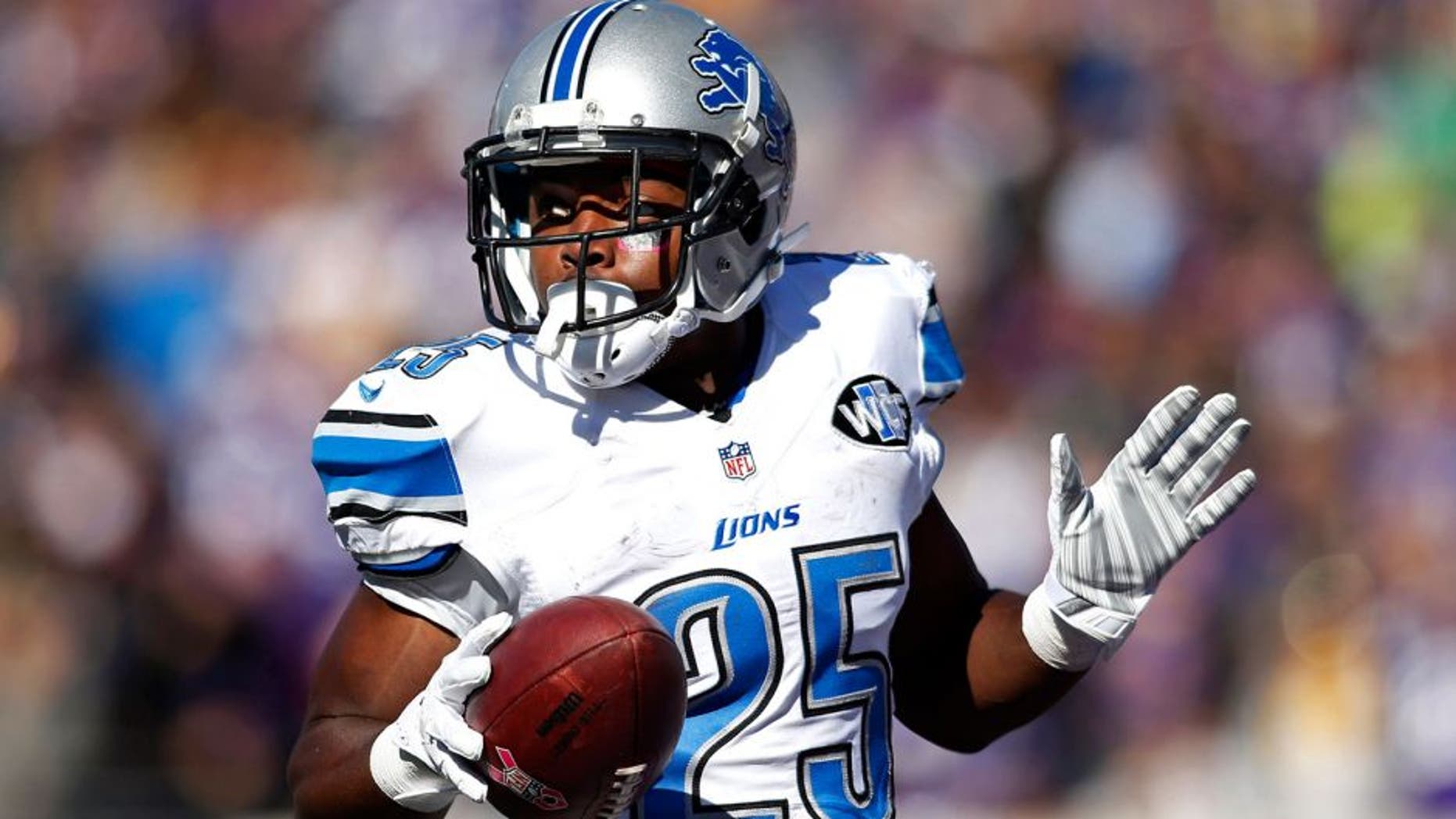 Oct 12, 2014; Minneapolis, MN, USA; Detroit Lions running back Theo Riddick (25) celebrates his touchdown against the Minnesota Vikings in the first quarter at TCF Bank Stadium. Mandatory Credit: Bruce Kluckhohn-USA TODAY Sports