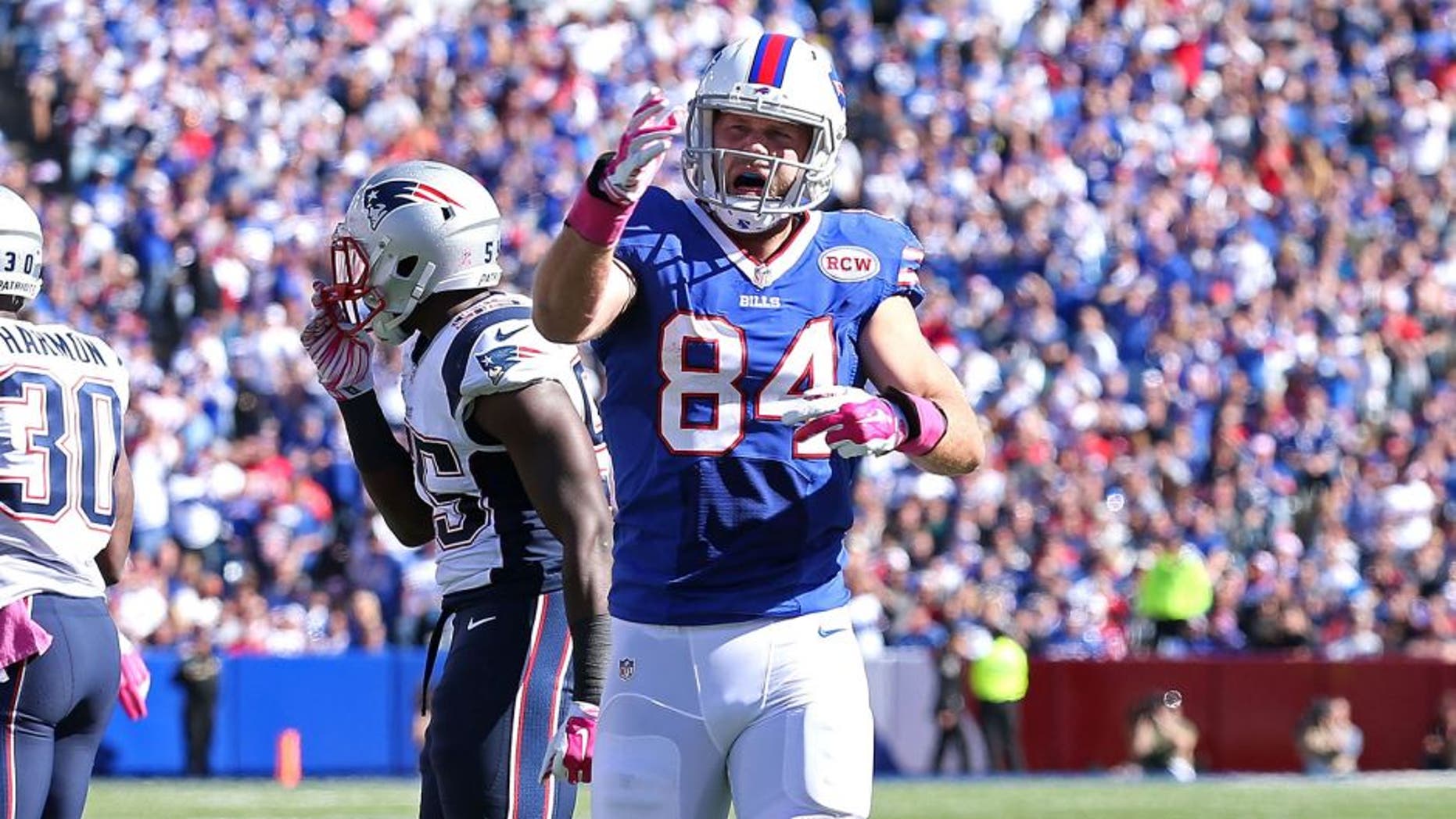 ORCHARD PARK, NY - OCTOBER 12: Scott Chandler #84 of the Buffalo Bills celebrates a first down catch against the New England Patriots during the first half at Ralph Wilson Stadium on October 12, 2014 in Orchard Park, New York. (Photo by Brett Carlsen/Getty Images)