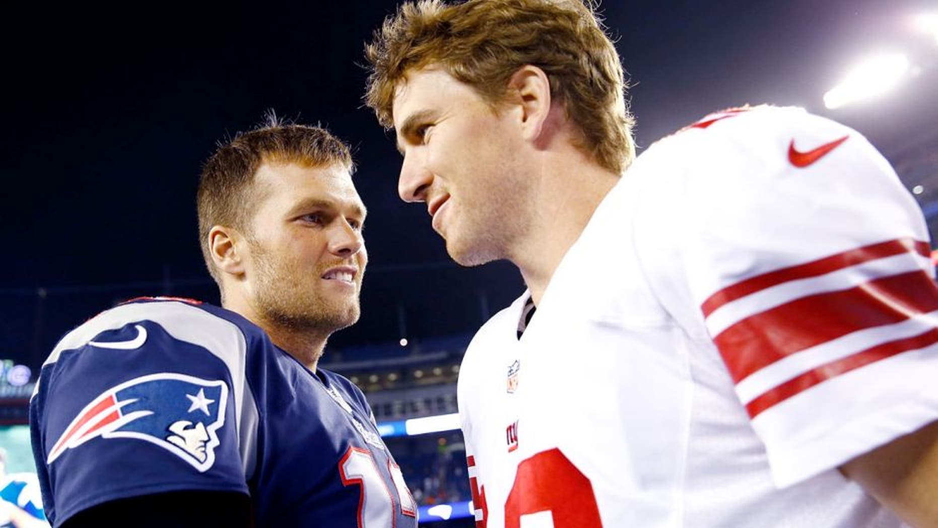 FOXBORO, MA - AUGUST 29: Tom Brady #12 of the New England Patriots talks to Eli Manning #10 of the New York Giants following their preseason game at Gillette Stadium on August 29, 2013 in Foxboro, Massachusetts. (Photo by Jared Wickerham/Getty Images)
