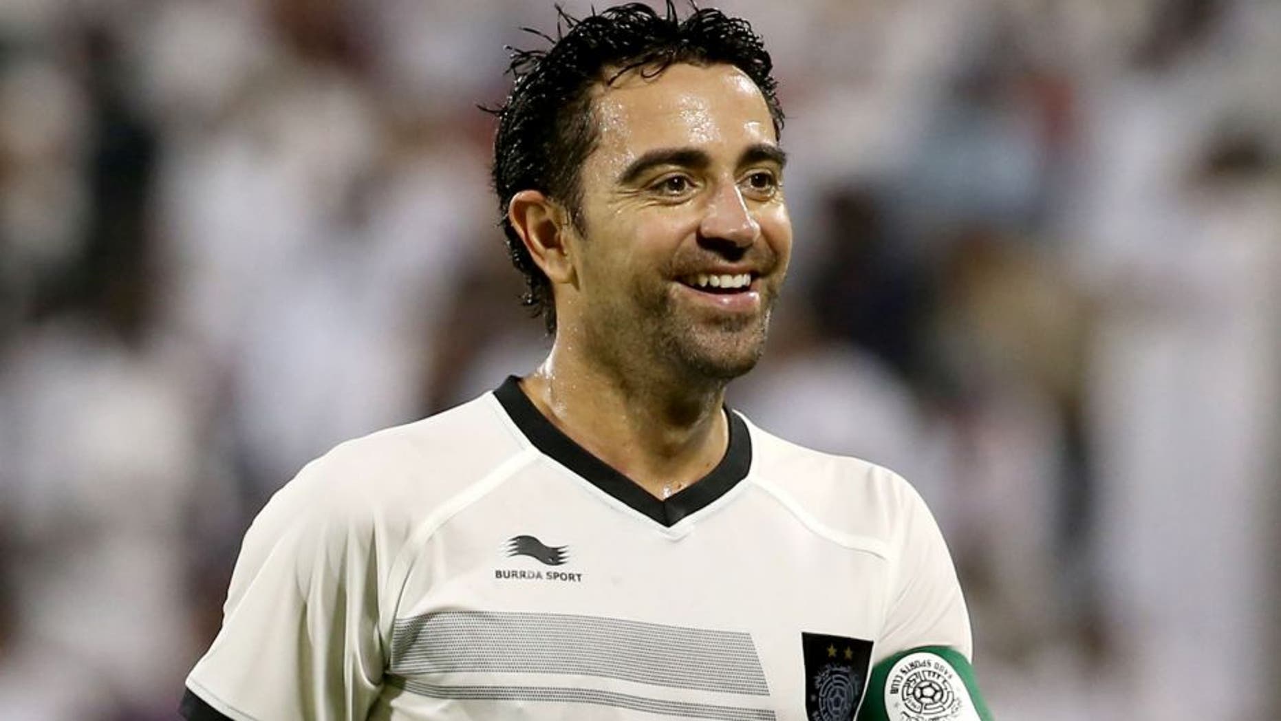 Barcelona football legend Xavi Hernandez who recently signed with Qatar's Al-Sadd club smiles during their Qatar Stars League football match against Al-Mesaimeer in Doha on September 13, 2015. AFP PHOTO / AL-WATAN DOHA / KARIM JAAFAR == QATAR OUT == (Photo credit should read KARIM JAAFAR/AFP/Getty Images)
