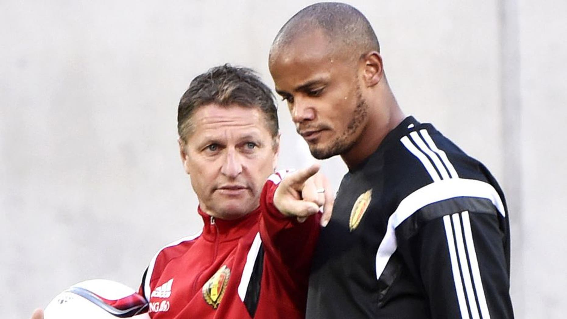 Belgium's Coach Marc Wilmots (L) and defender Vincent Kompany attend a training session at the Estadi Comunal in Andorra la Vella on October 10, 2015, on the eve of the Euro2016 qualifying group D football match Andorra against Belgium. AFP PHOTO / PASCAL PAVANI (Photo credit should read PASCAL PAVANI/AFP/Getty Images)