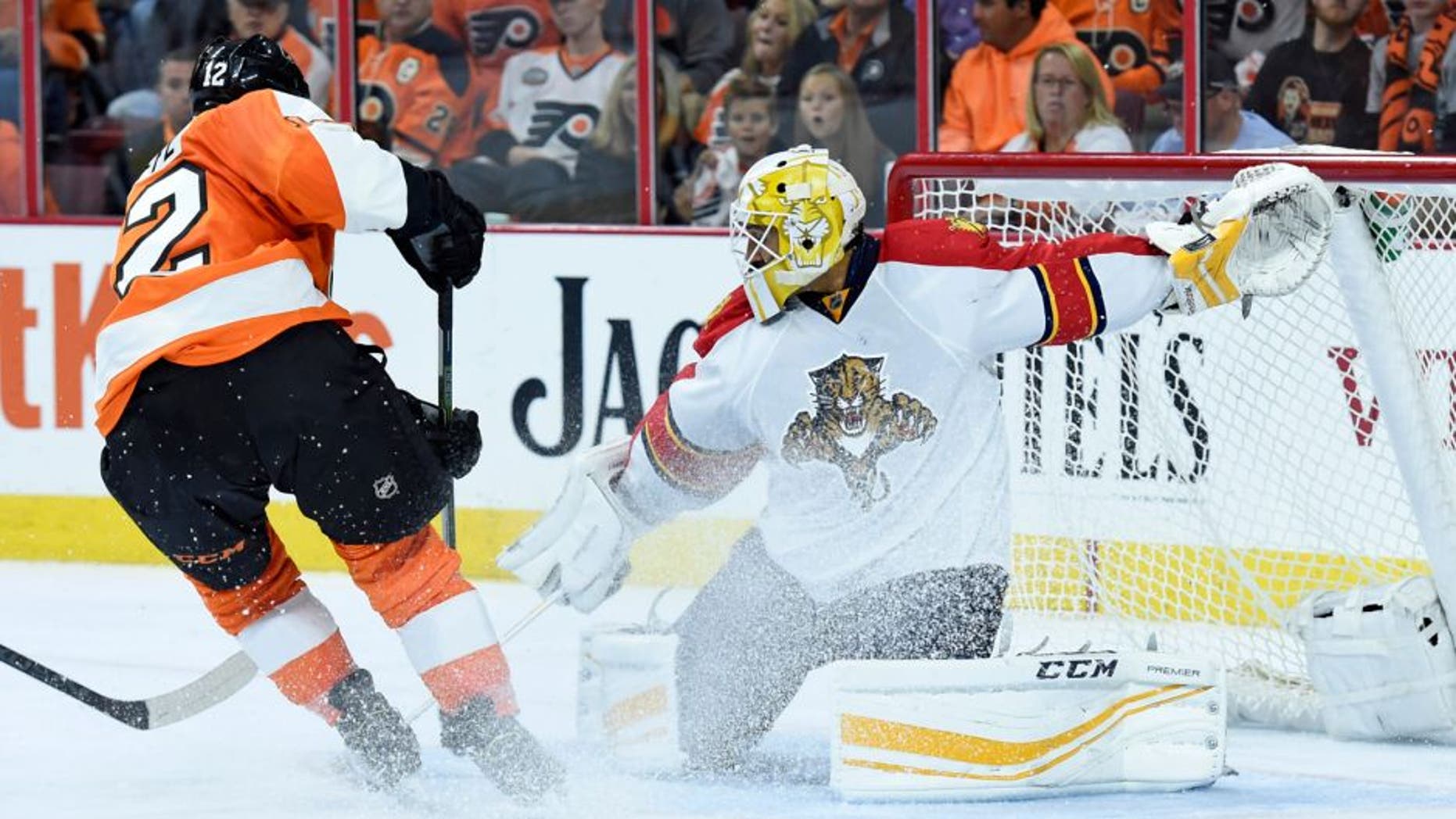 Oct 12, 2015; Philadelphia, PA, USA; Philadelphia Flyers left wing Michael Raffl (12) has his shot stopped by Florida Panthers goalie Roberto Luongo (1) during the second period at Wells Fargo Center. Mandatory Credit: Eric Hartline-USA TODAY Sports