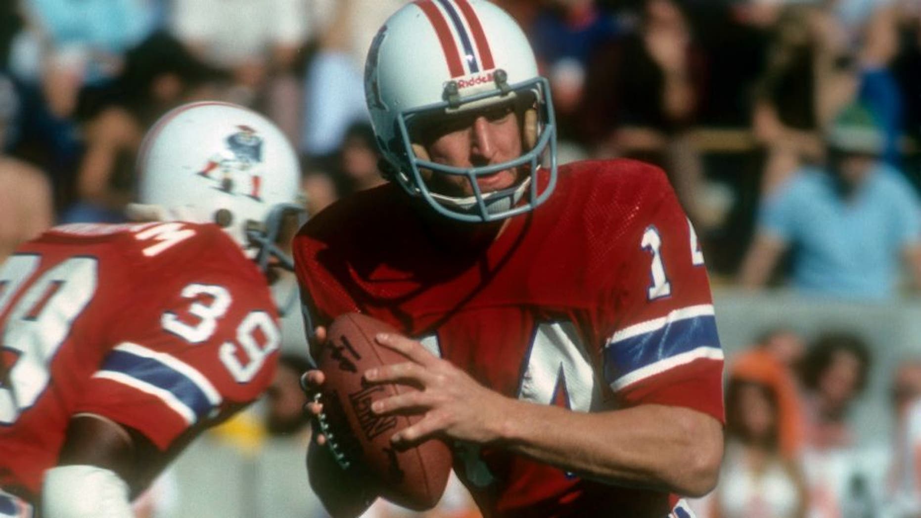 TAMPA BAY, FL - DECEMBER 12: Quarterback Steve Grogan #14 of the New England Patriots drops back to pass against the Tampa Bay Buccaneers during an NFL football game at Tampa Stadium December 12, 1976 in Tampa Bay, Florida. Grogan played for the Patriots from 1975-90. (Photo by Focus on Sport/Getty Images)