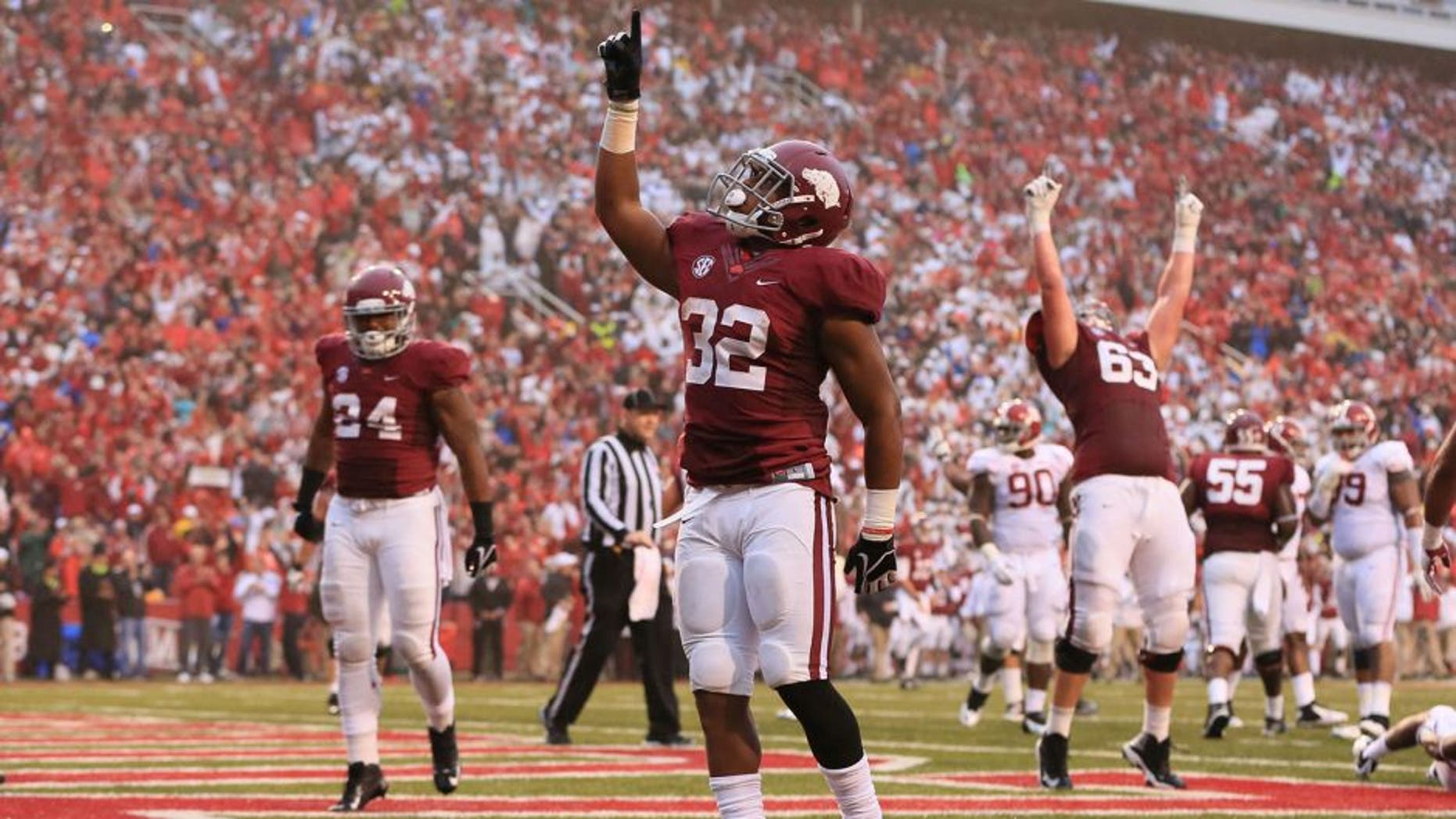 Oct 11, 2014; Fayetteville, AR, USA; Arkansas Razorbacks running back Jonathan Williams (32) celebrates after scoring a touchdown in the second quarter against the Alabama Crimson Tide at Donald W. Reynolds Razorback Stadium. Mandatory Credit: Nelson Chenault-USA TODAY Sports