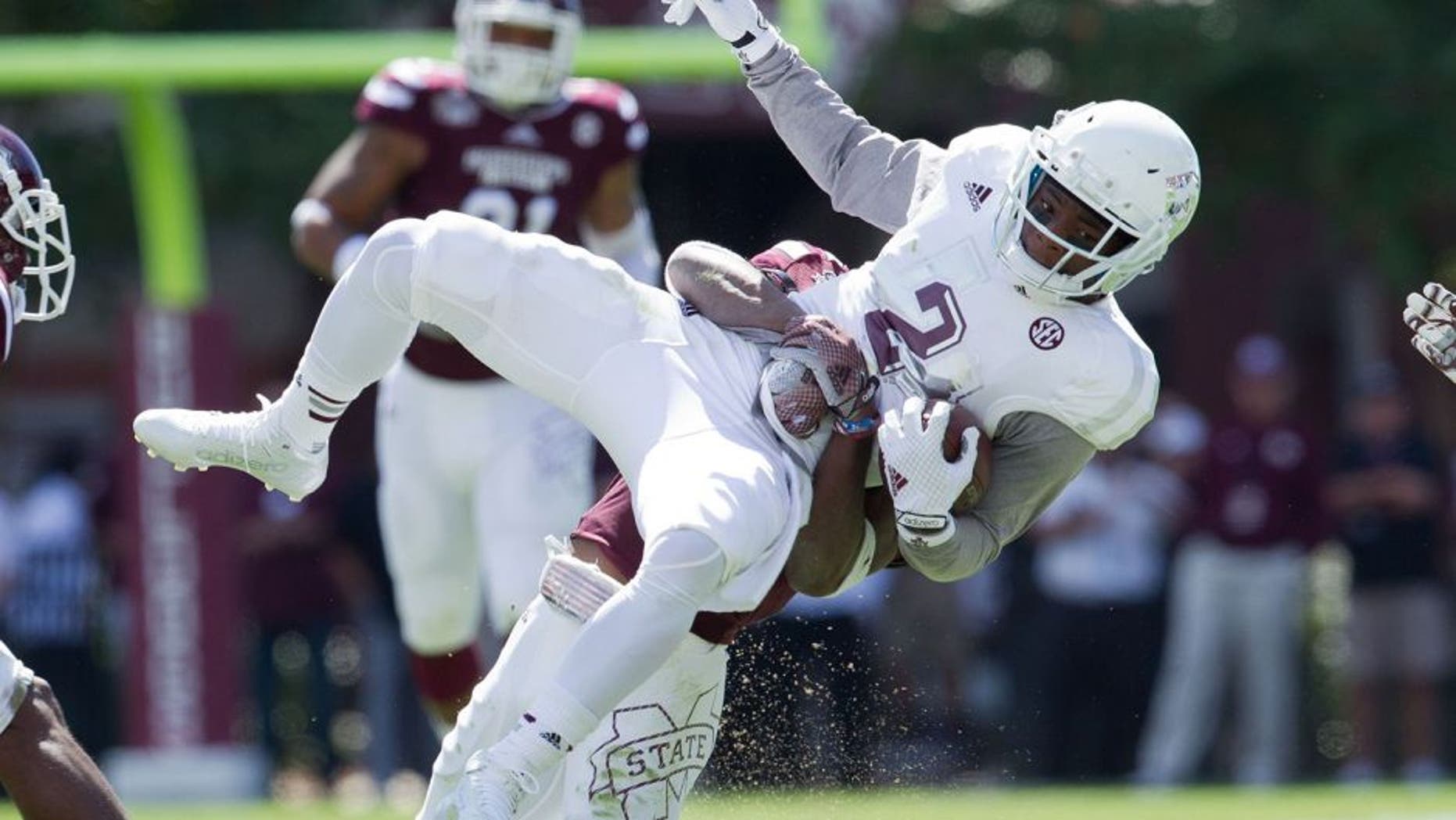 Oct 4, 2014; Starkville, MS, USA; Texas A&M Aggies wide receiver Speedy Noil (2) is grabbed by Mississippi State Bulldogs defensive back Taveze Calhoun (23) at Davis Wade Stadium. Mandatory Credit: Marvin Gentry-USA TODAY Sports