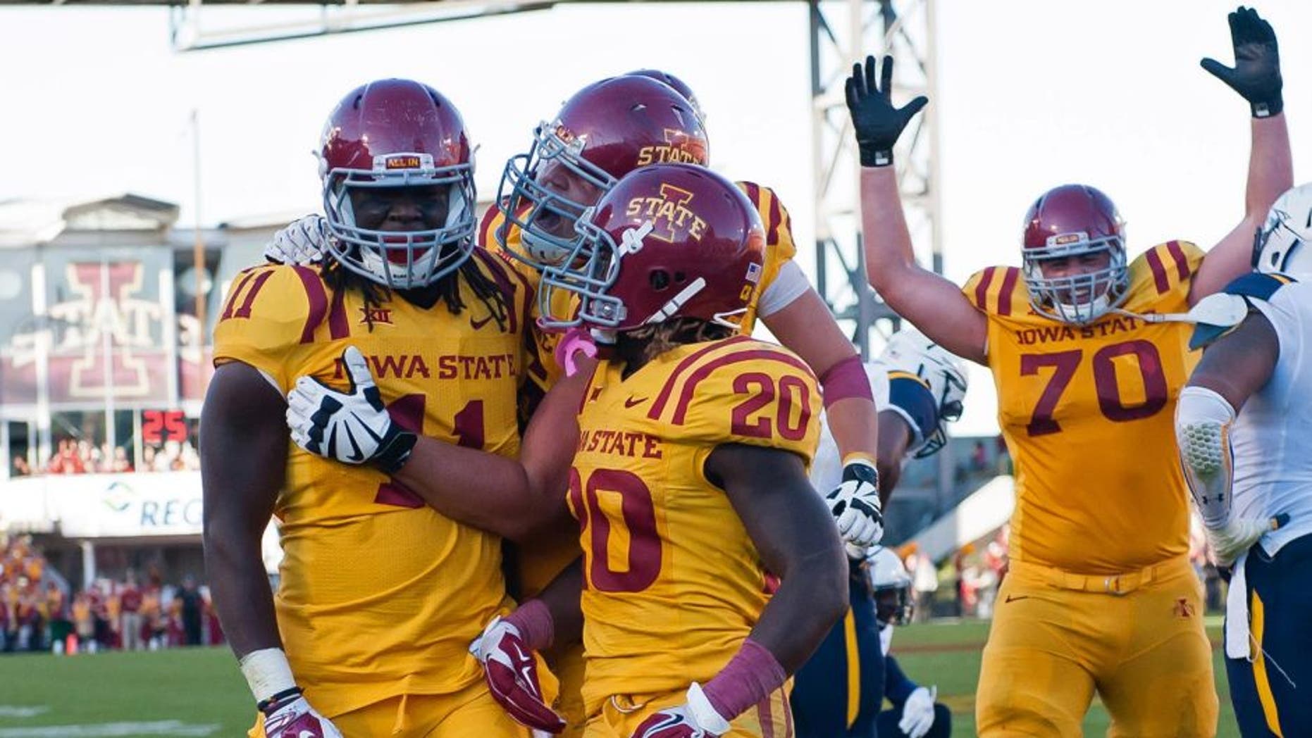 Oct 11, 2014; Ames, IA, USA; Iowa State Cyclones tight end E.J. Bibbs (11) celebrates with running back DeVondrick Nealy (20) and offensive lineman Daniel Burton (70) after scoring against the Toledo Rockets at Jack Trice Stadium. Iowa State defeated Toledo 37-30. Mandatory Credit: Steven Branscombe-USA TODAY Sports