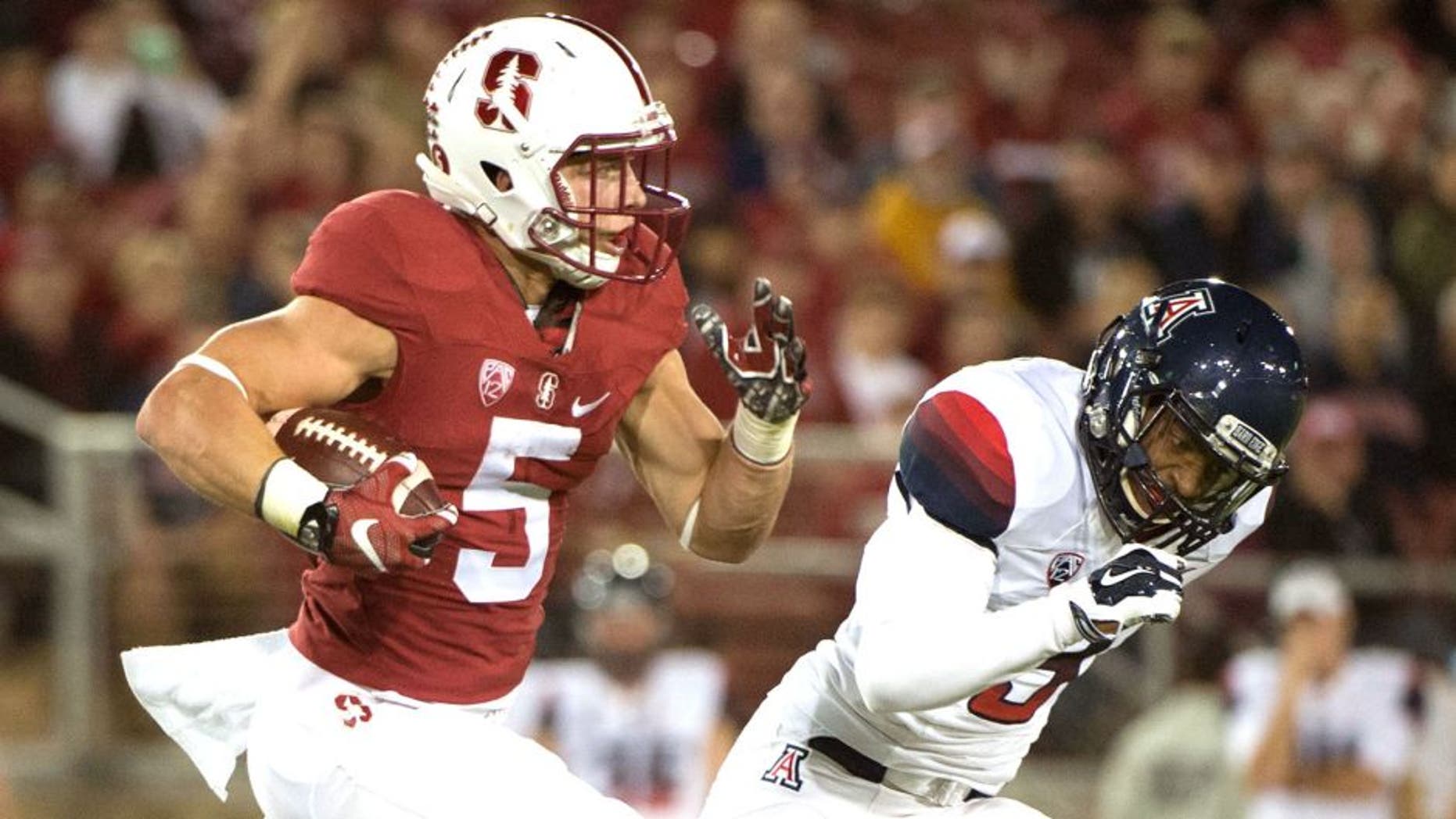 October 3, 2015; Stanford, CA, USA; Stanford Cardinal running back Christian McCaffrey (5) runs the football against Arizona Wildcats cornerback Cam Denson (3) during the first quarter at Stanford Stadium. Mandatory Credit: Kyle Terada-USA TODAY Sports