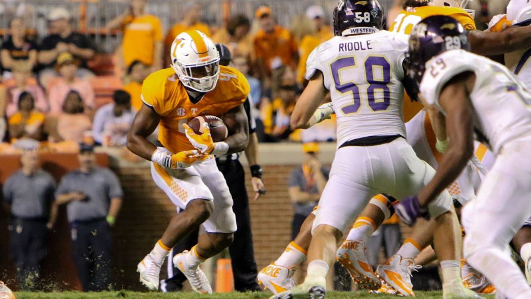 Sep 19, 2015; Knoxville, TN, USA; Tennessee Volunteers running back John Kelly (4) runs the ball during the second half against the Western Carolina Catamounts at Neyland Stadium. Tennessee won 55 to10. Mandatory Credit: Randy Sartin-USA TODAY Sports