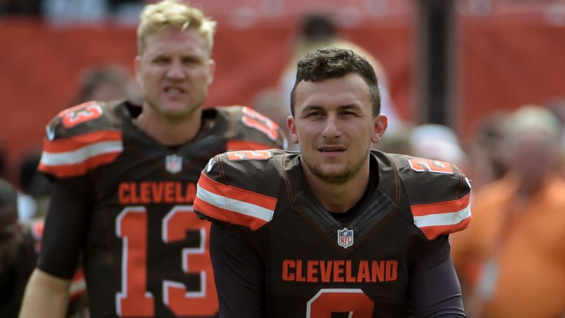 Sep 27, 2015; Cleveland, OH, USA; Cleveland Browns quarterbacks Johnny Manziel (2) and Josh McCown (13) stretch before a NFL game against the Oakland Raiders at FirstEnergy Stadium.
