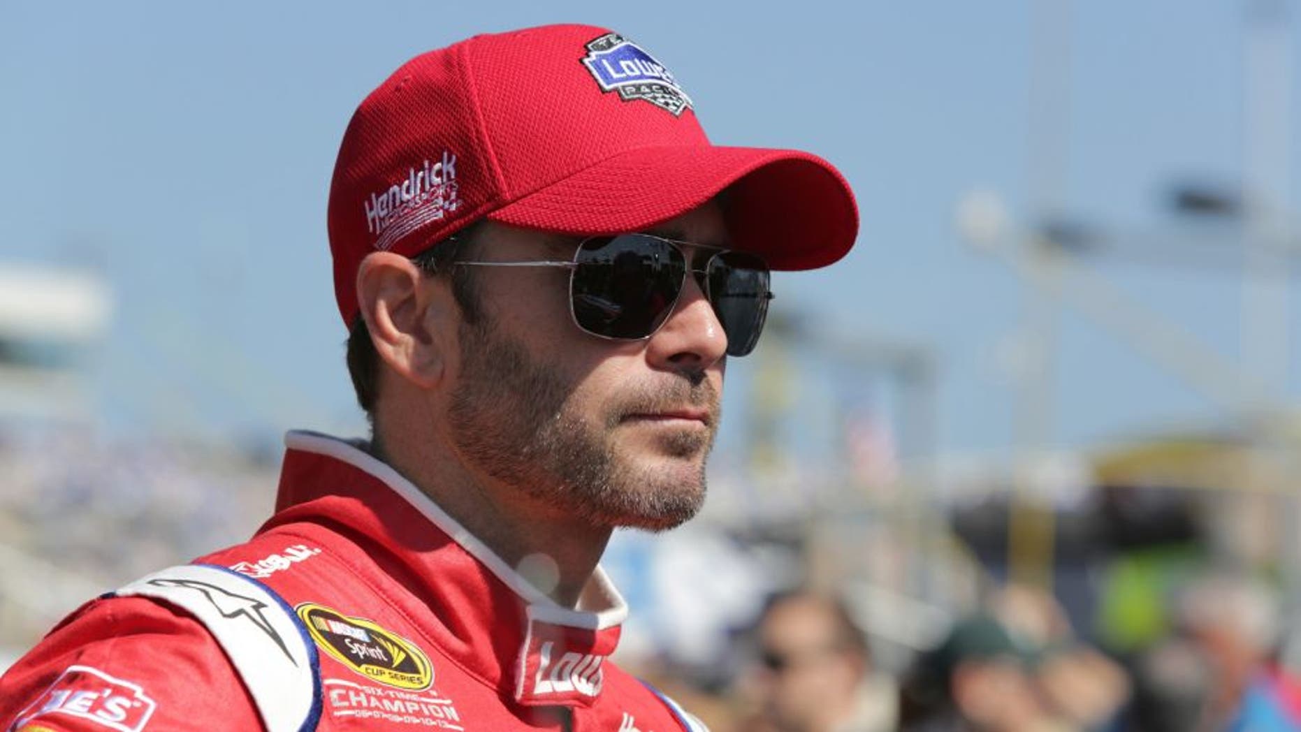 CHARLOTTE, NC - OCTOBER 11: Jimmie Johnson, driver of the #48 Lowe's Red Vest Chevrolet, stands on the grid during the NASCAR Sprint Cup Series Bank of America 500 at Charlotte Motor Speedway on October 11, 2015 in Charlotte, North Carolina. (Photo by Jerry Markland/Getty Images)