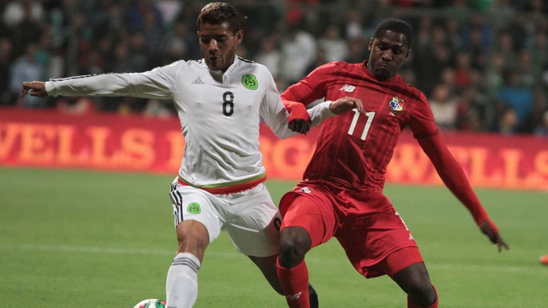 Jonathan Dos Santos (L) of Mexico vies for the ball with Armando Cooper (R) of Panama during their friendly match at the Nemesio Diez stadium on October 13, 2015, in Toluca ,Mexico. AFP PHOTO/MARIA CALLS (Photo credit should read MARIA CALLS/AFP/Getty Images)