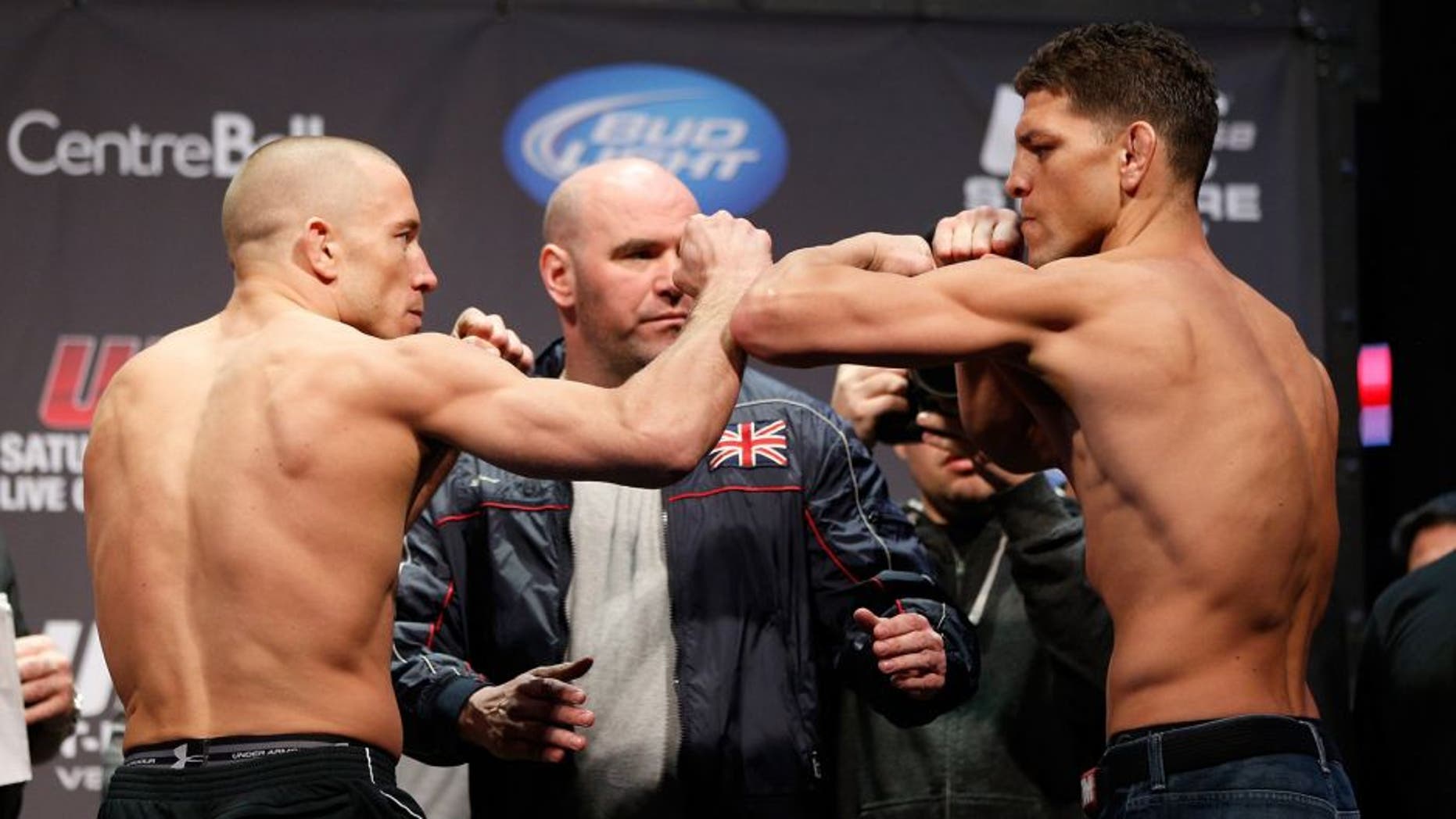 MONTREAL, QC - MARCH 15: Georges St-Pierre (L) and Nick Diaz (R) face off during the UFC 158 weigh-in at Bell Centre on March 15, 2013 in Montreal, Quebec, Canada. (Photo by Josh Hedges/Zuffa LLC/Zuffa LLC via Getty Images)