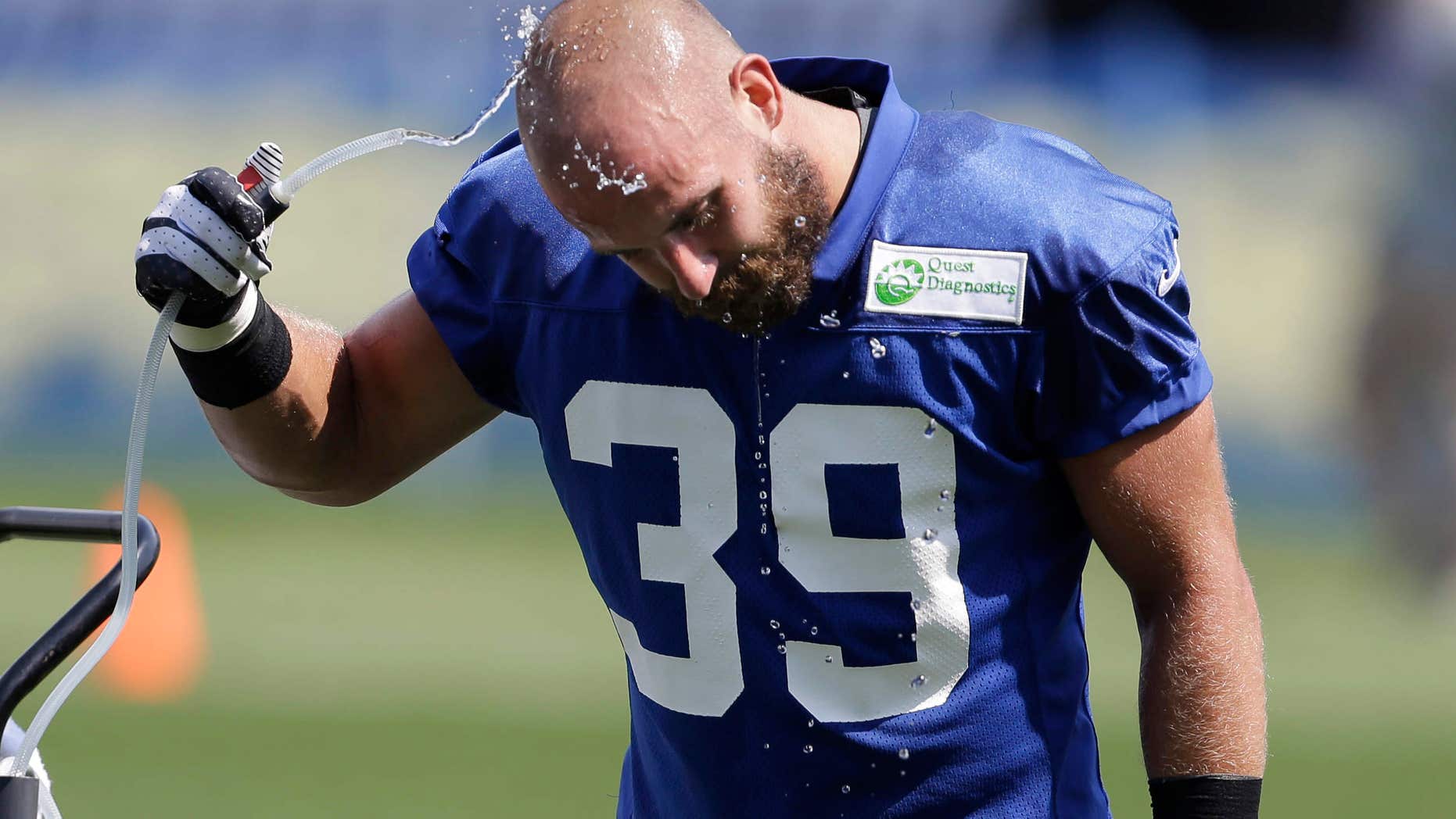 FILE - In this Saturday, July 27, 2013, file photo, New York Giants safety Tyler Sash cools off at a water fountain during NFL football training camp in East Rutherford, N.J.