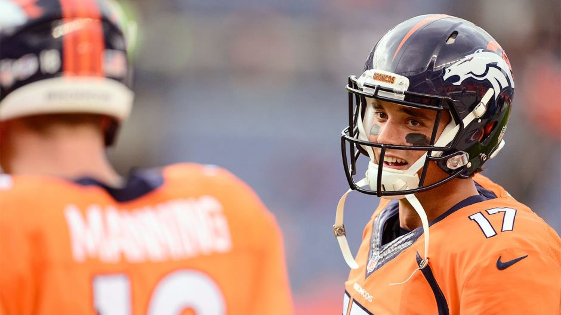 Sep 3, 2015; Denver, CO, USA; Denver Broncos quarterback Brock Osweiler (17) talks to quarterback Peyton Manning (18) before the preseason game against the Arizona Cardinals at Sports Authority Field at Mile High. Mandatory Credit: Ron Chenoy-USA TODAY Sports