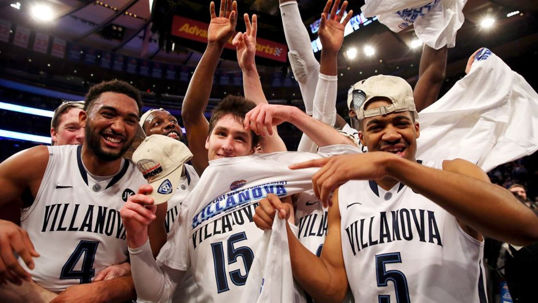 NEW YORK, NY - MARCH 14: Darrun Hilliard #4, Ryan Arcidiacono #15, and Phil Booth #5 of the Villanova Wildcats celebrate on the court after defeating the Xavier Musketeers 69-52 in the championship game of the Big East basketball tournament at Madison Square Garden on March 14, 2015 in New York City. (Photo by Elsa/Getty Images)