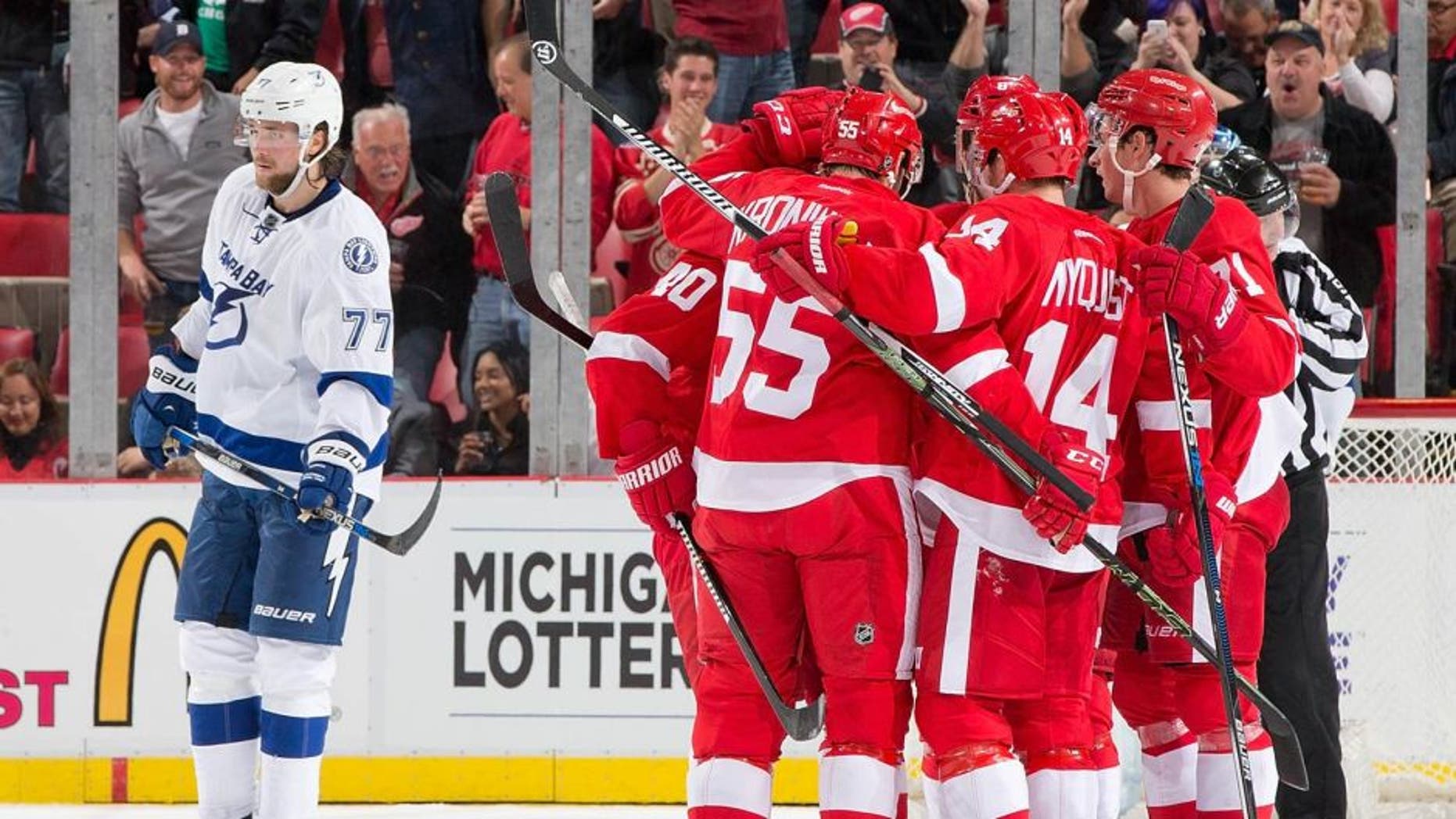 DETROIT, MI - OCTOBER 13: Gustav Nyquist #14 of the Detroit Red Wings celebrates his second period goal with teammates Niklas Kronwall #55, Gustav Nyquist #14, Henrik Zetterberg #40 and Dylan Larkin #71 during an NHL game against the Tampa Bay Lightning at Joe Louis Arena on October 13, 2015 in Detroit, Michigan. (Photo by Dave Reginek/NHLI via Getty Images)